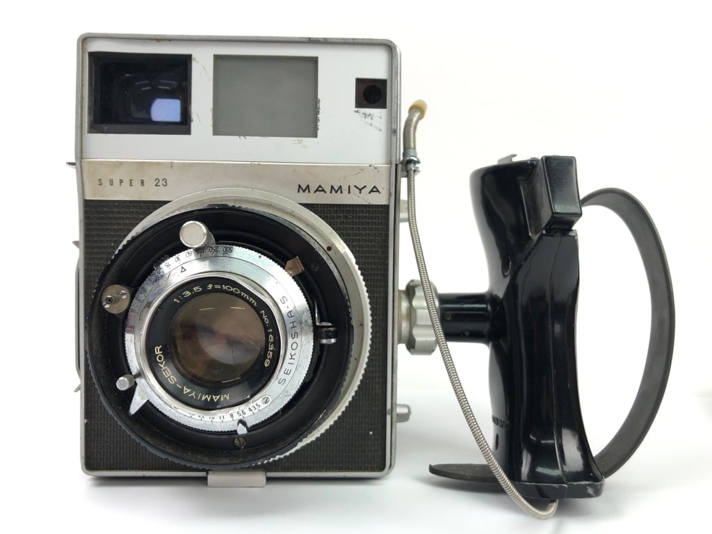 Mamiya Super 23 Camera w Sekor 100mm f/3.5 Lens: Vintage Mamiya Super 23 medium format camera with a 100mm f/3.5 Sekor lens. Features a Graflex back, rangefinder focusing mechanism, and detachable film back. Made in Japan by Mamiya Camera Co., Ltd.