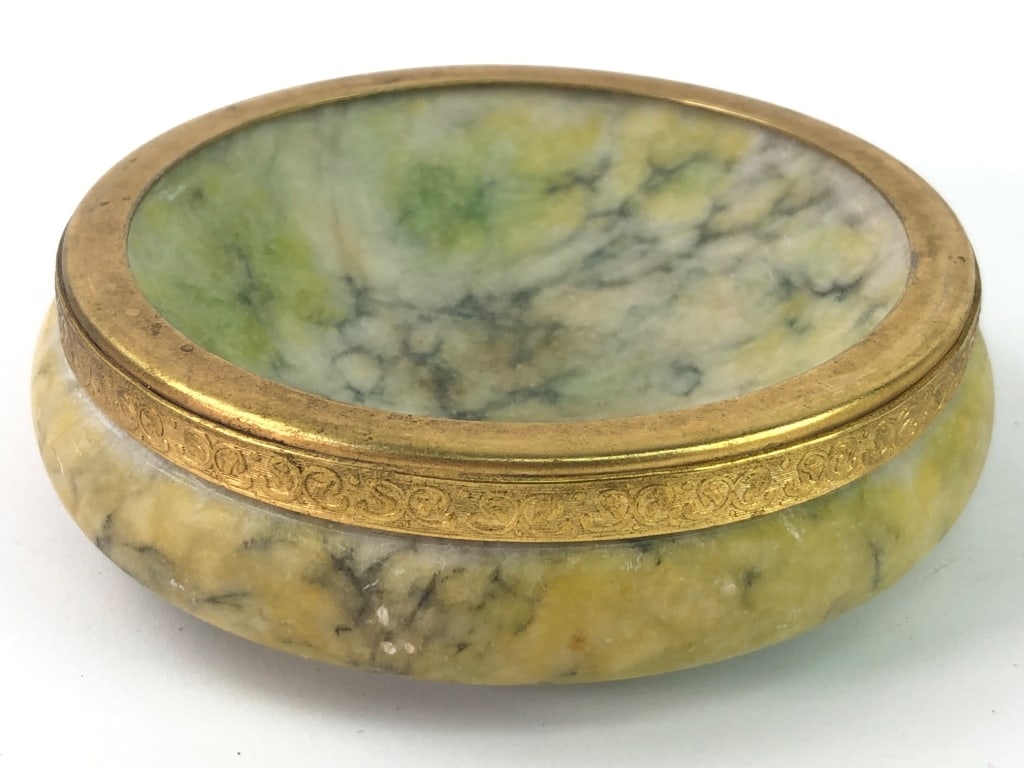 Carved Soapstone/Alabaster Round Trinket Dish: Round trinket dish made from soapstone or alabaster with a gold-toned bras rim featuring ornate detailing. Rim can be removed. " Suitable for decorative or functional use, with felt pads at the base.