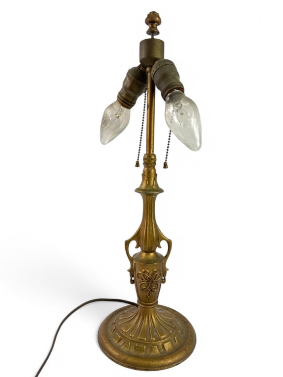 Attributed To H.G. McFadden & Co Bellova Lamp: Attributed to H.G. McFadden & Co, this 21-inch cast metal lamp features a detailed base and floral motifs. Unsigned with light chipping to paint. Dual sockets with pull chains. Working condition.