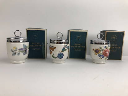 Royal Worcester Egg Coddlers With Boxes: Set of three Royal Worcester egg coddlers made of flameproof porcelain. Each features a floral design with a chrome screw-top lid. Original boxes and instructions included. Made in England.