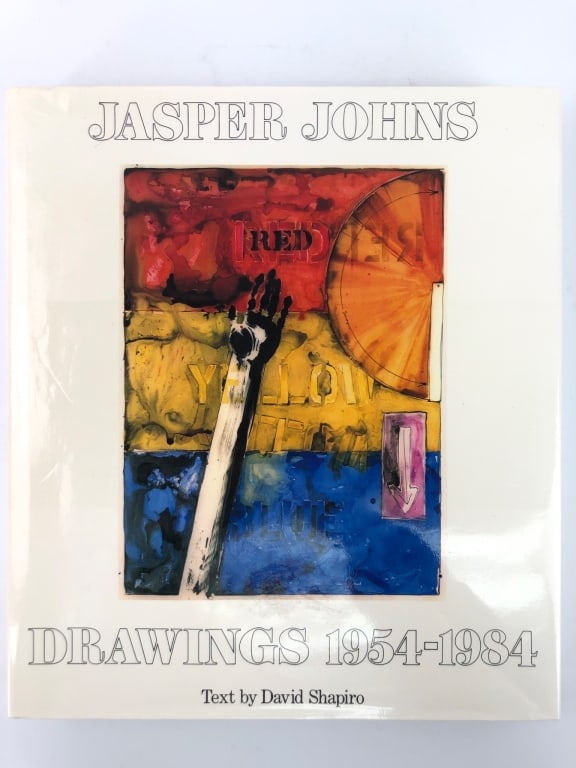 Jasper Johns Drawings 1954-1984 Book: First edition hardcover book with dust jacket published in 1984. Text by David Shapiro. Former library copy with some damage to the cloth cover. Features artwork and essays.