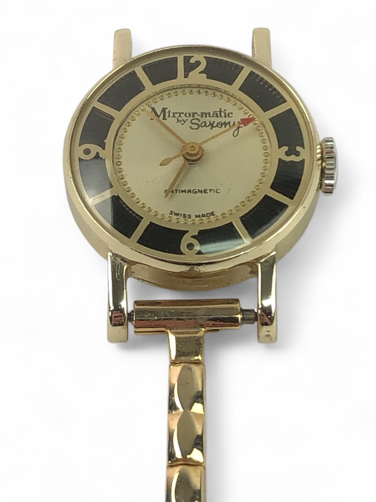 Mirror-Matic By Saxony Swiss Watch: Mirror-Matic by Saxony wristwatch featuring Swiss-made 7-jewel movement. Anti-magnetic design with a gold-tone case and band. The watch is unadjusted and features decorative detailing.