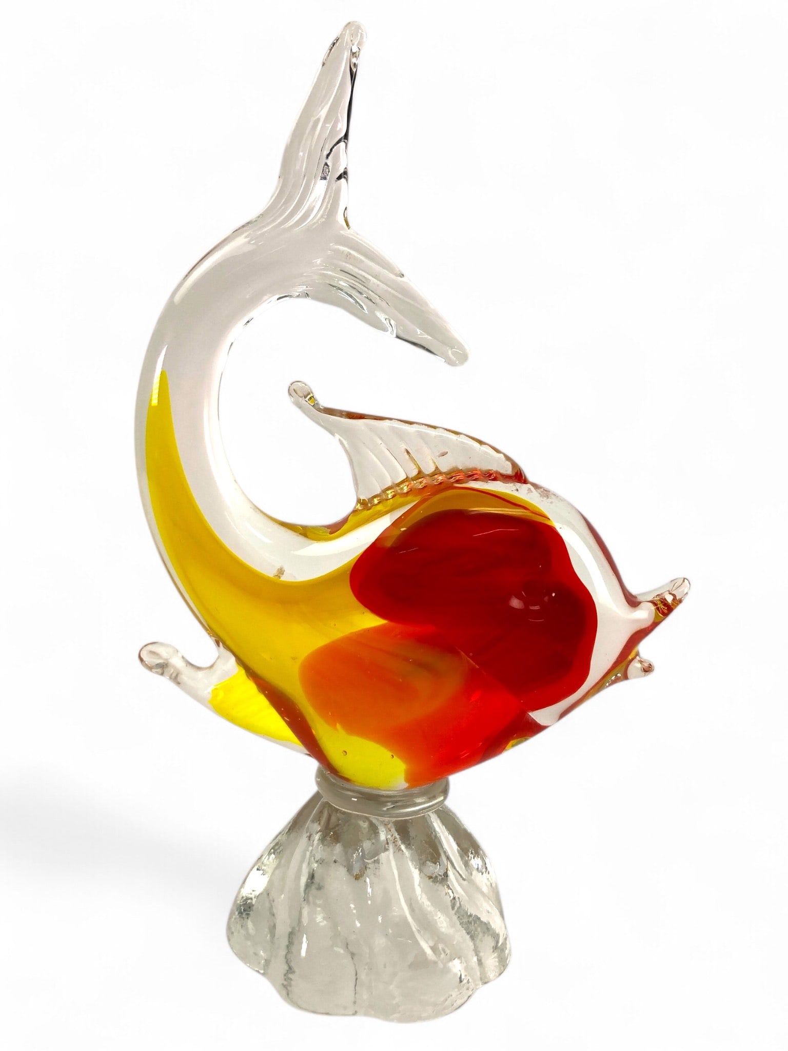 Art Glass Fish Sculpture: Art glass fish sculpture attributed to Murano. Featuring swirling red, yellow, and orange hues with a clear glass base. Measures approximately 9" in height.
