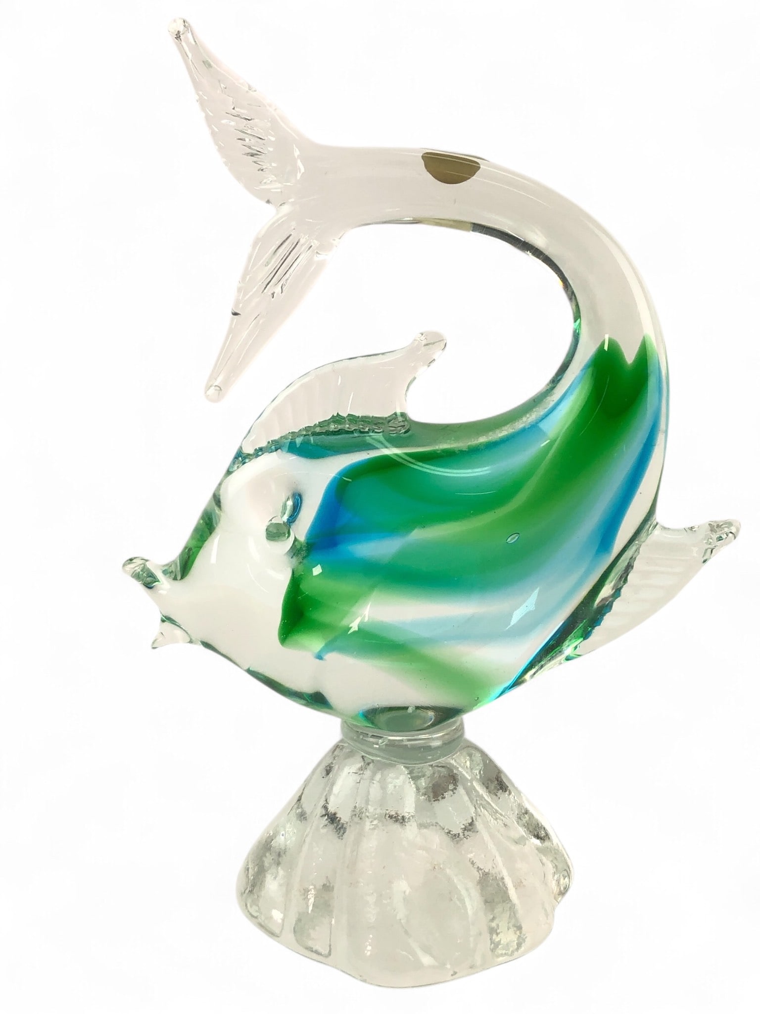 Murano Art Glass Fish Sculpture: Murano art glass fish sculpture featuring clear, green, and blue glass with a swirl design. Stands 7 5/8 inches tall on a clear scalloped base. Marked 'Murano Venezia' on a sticker.