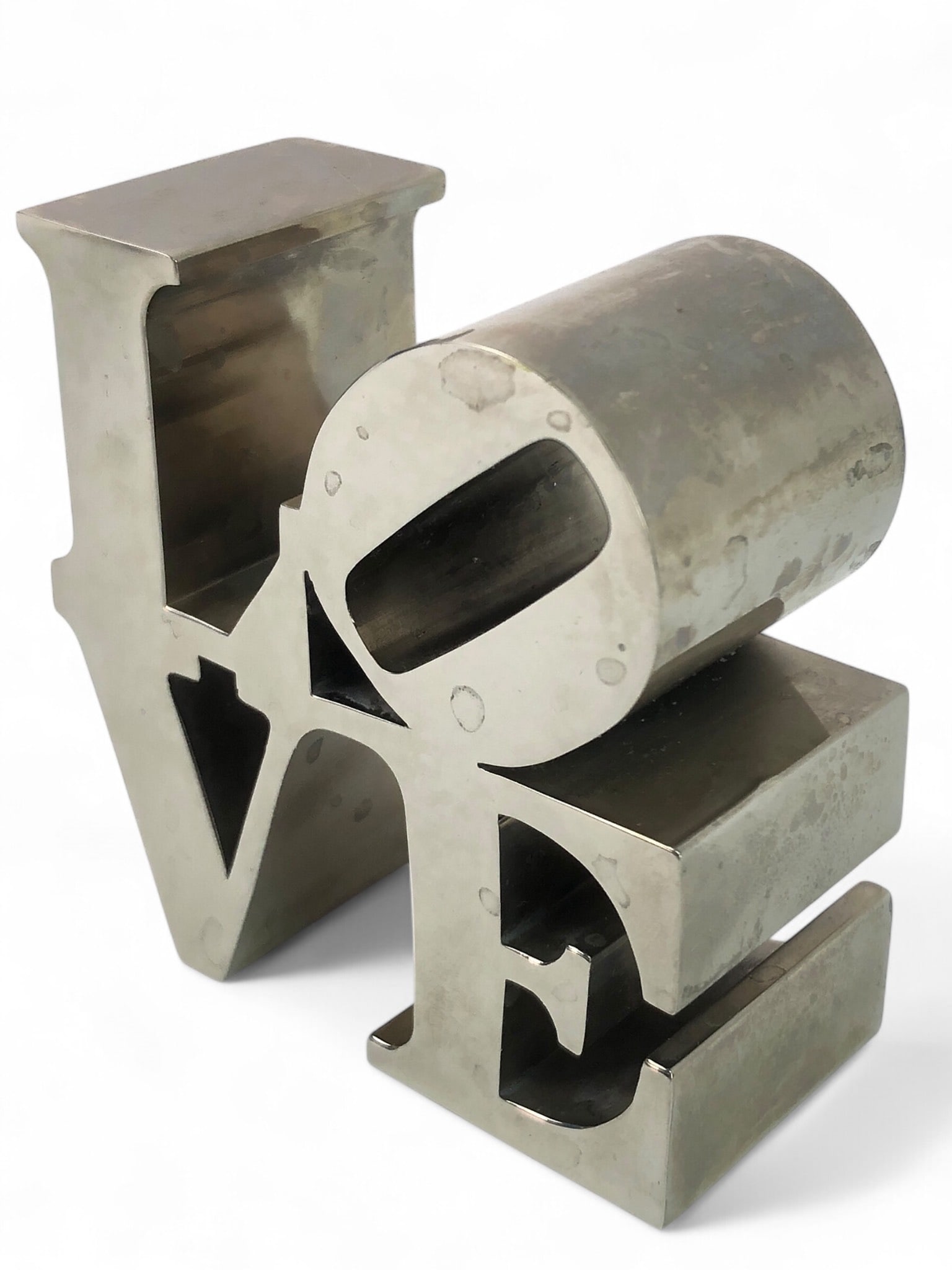 Vtg 1975 Robert Indiana LOVE Sculpture: Vintage 1975 Robert Indiana LOVE sculpture paperweight, approximately 3 inches tall. Iconic design in polished metal showing slight wear consistent with age. A collectible piece.
