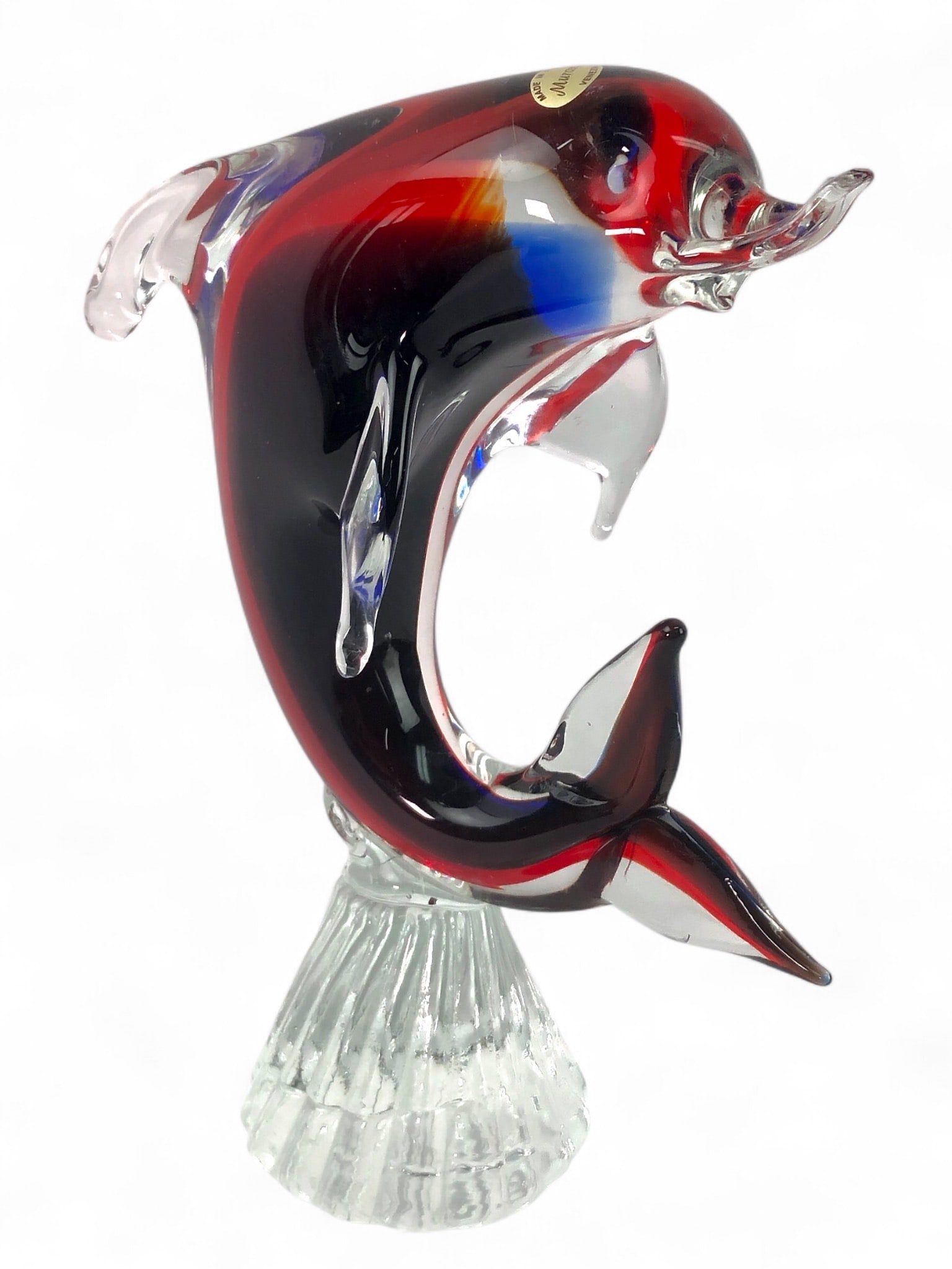 Murano Art Glass Dolphin Sculpture: Murano art glass dolphin sculpture measuring 9 inches tall. Features a vibrant multicolor design and clear glass base. Some surface scratches are present on the dolphin's face.
