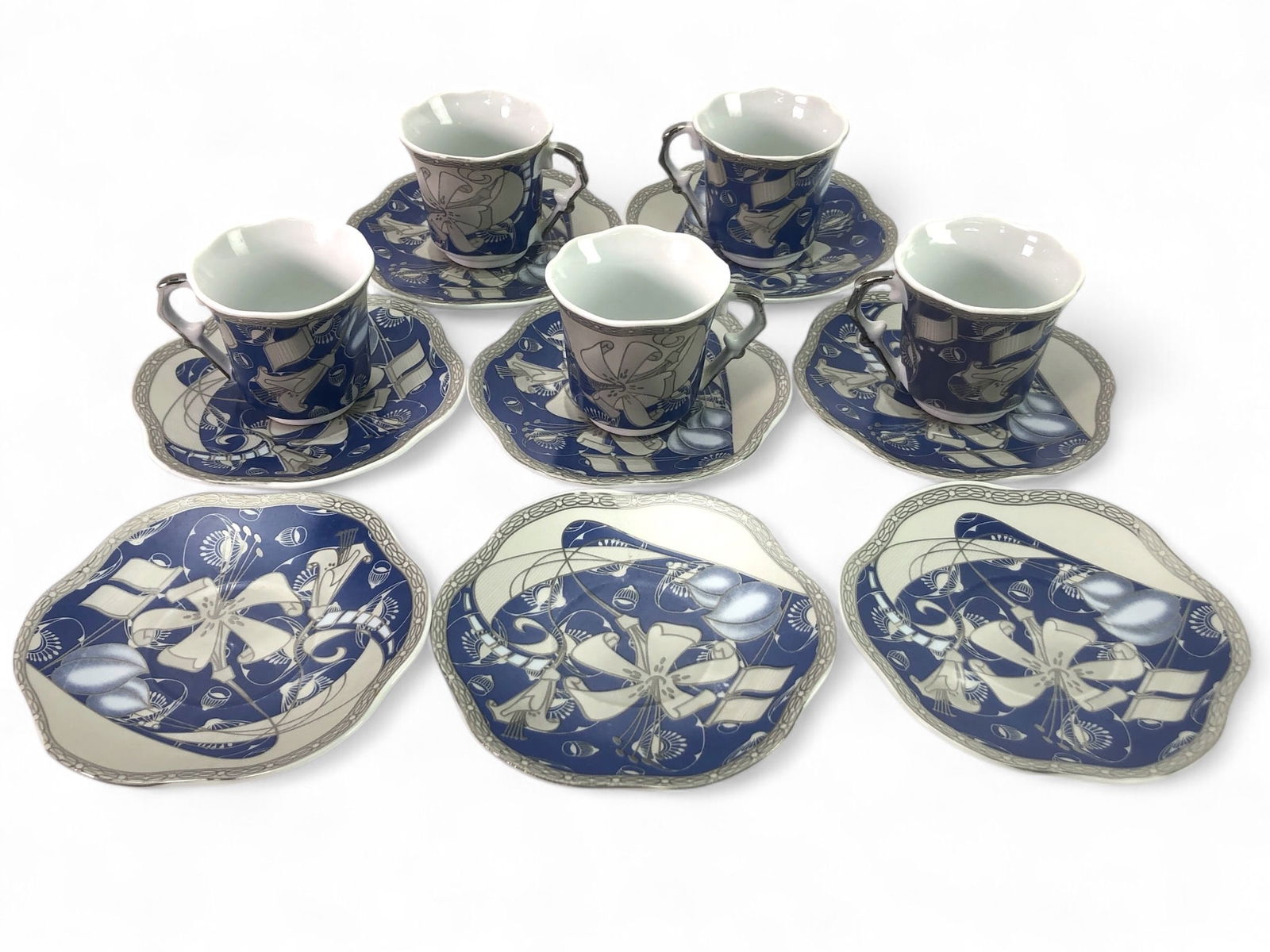 Alghanem 5 Tea Cups 8 Saucers Set: 5 Alghanem tea cups and 8 saucers featuring decorative blue and white patterns. Tea cups are 2 1/8 inches tall, and saucers have a 4.25-inch diameter. Marked 'Made in China' on the base.