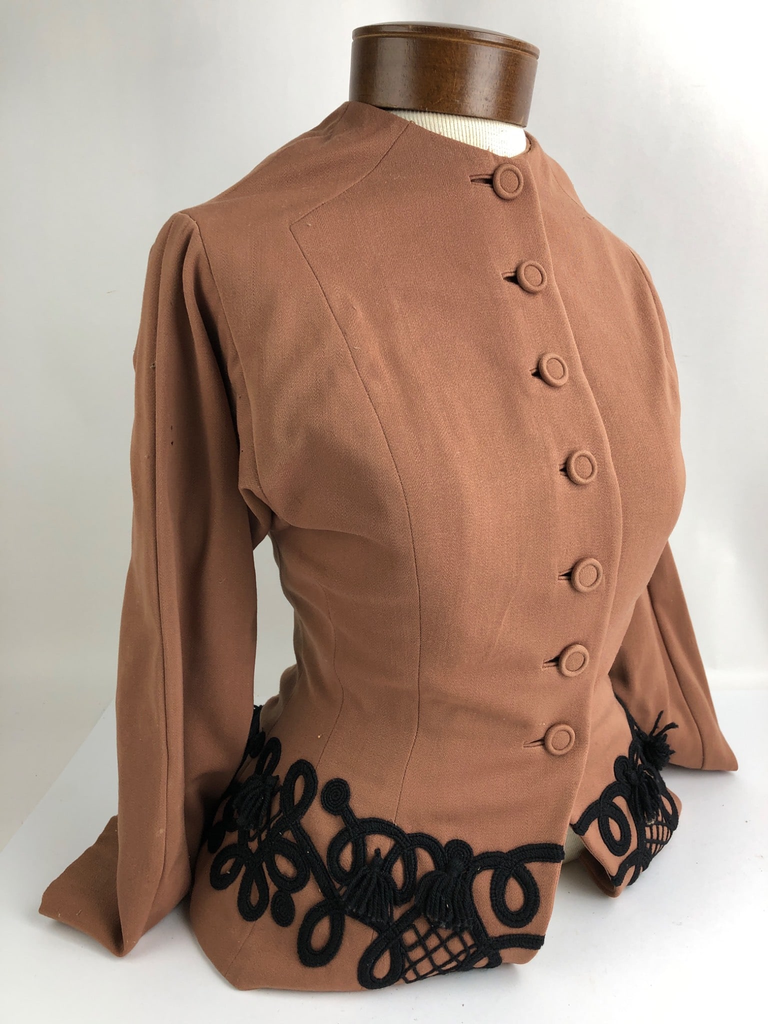 Antique Victorian Clothing With Mannequin: Antique Victorian-era woman's clothing crafted in brown fabric with black embellishments, displayed on a fabric mannequin measuring 22" tall x 14" wide. Includes visible wear consistent with age.