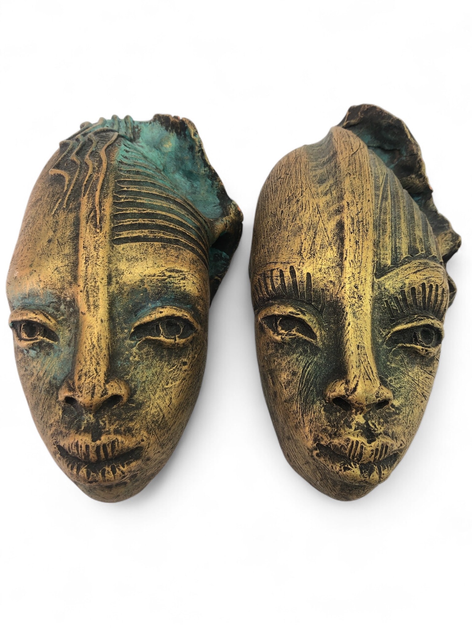 Signed Painted Clay Masks 7 3/4"Long: Signed painted clay masks, each measuring 7 3/4 inches in length. Featuring textured and painted gold and green finishes with detailed carvings. Signatures visible on the reverse side.