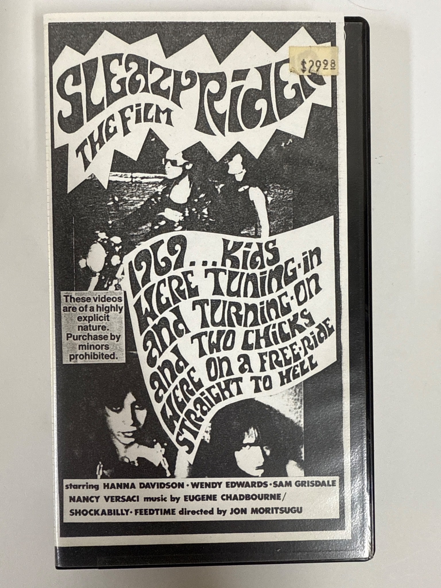 Der Elvis/Sleazy Rider VHS Tape: VHS tape containing the films 'Der Elvis' and 'Sleazy Rider,' directed by Jon Moritsugu. Includes original black-and-white cover art and promotional inserts. Rated for mature audiences.