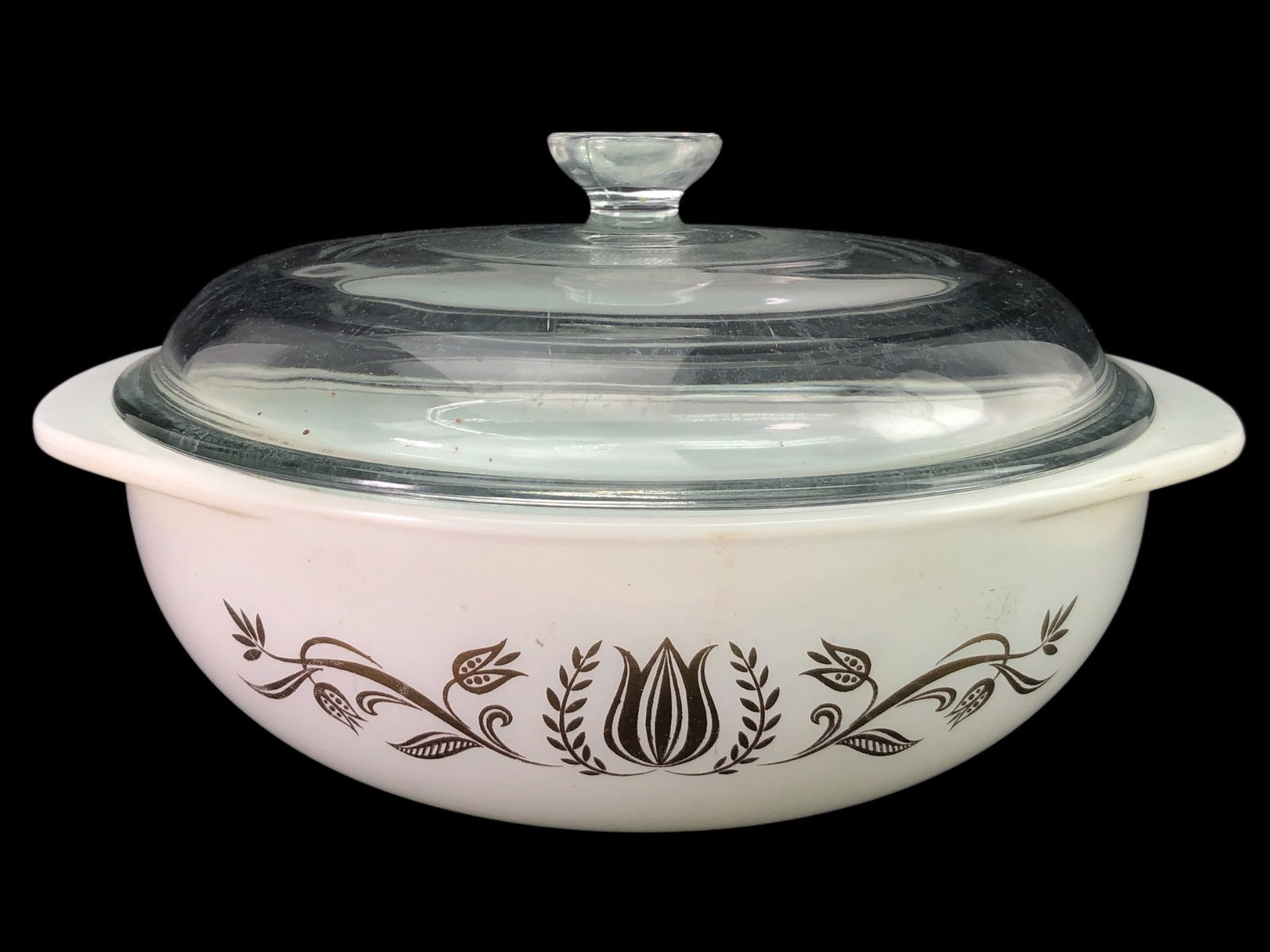 Rare Promo 1962 Pyrex Golden Tulip Casserole Dish: Rare 1962 promotional Pyrex Golden Tulip round casserole dish with lid. Features an 8 5/8" diameter and Golden Tulip design on milk glass. Includes clear glass lid.