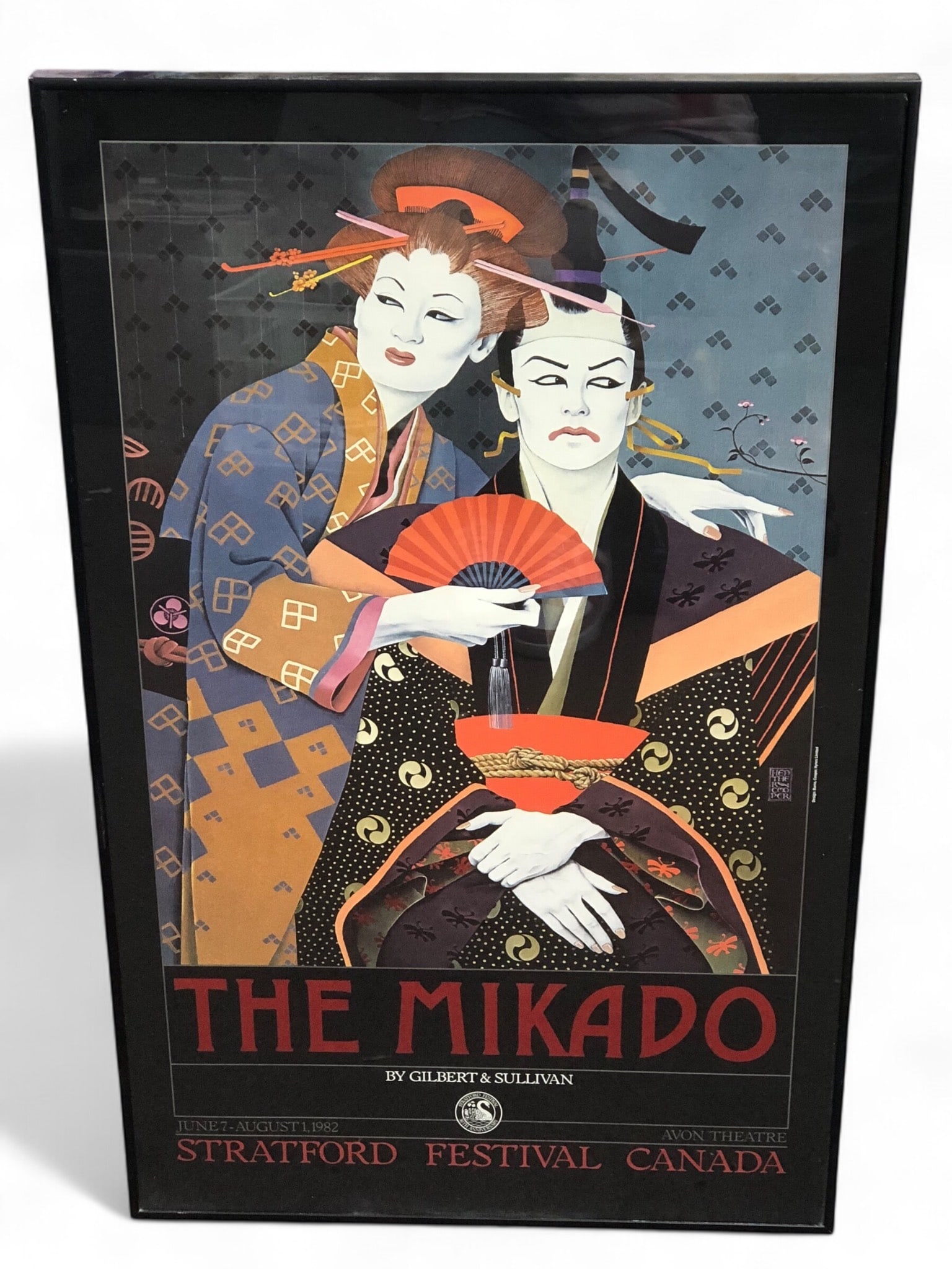 The Mikado Stratford Festival Poster: Framed poster for the Stratford Festival"s production of "The Mikado" by Gilbert & Sullivan, dated June 7 to August 1, 1982. Features design by Burns, Cooper, and Hynes Limited. Dimensions: 21 x 34.5 
