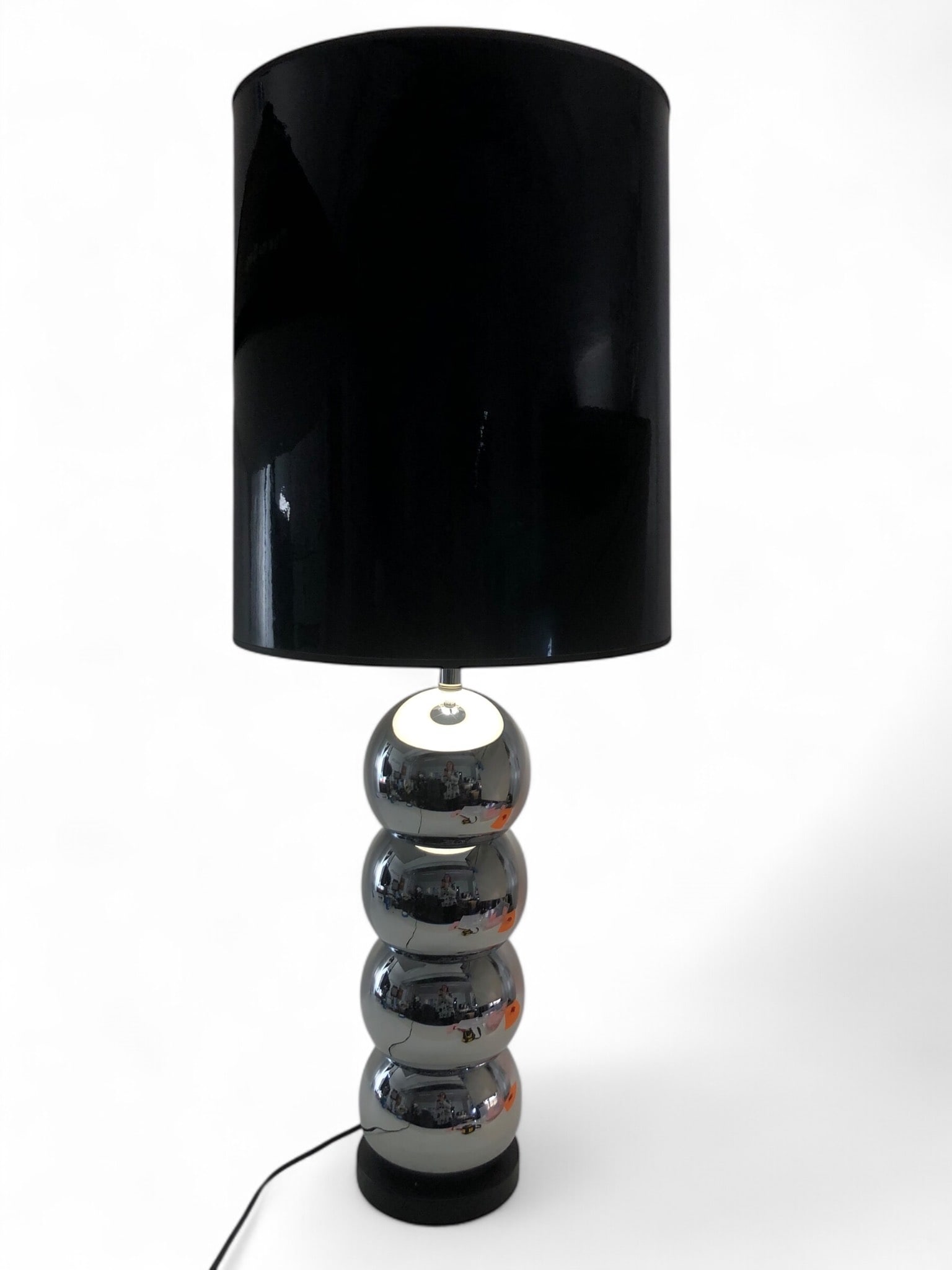 George Kovacs Chrome Stacked Ball Lamp: George Kovacs attributed chrome stacked ball lamp with a black shade. Lamp measures 33 inches tall, and shade measures 17 inches tall. Tested and working. Shade shows minor water staining on the inter