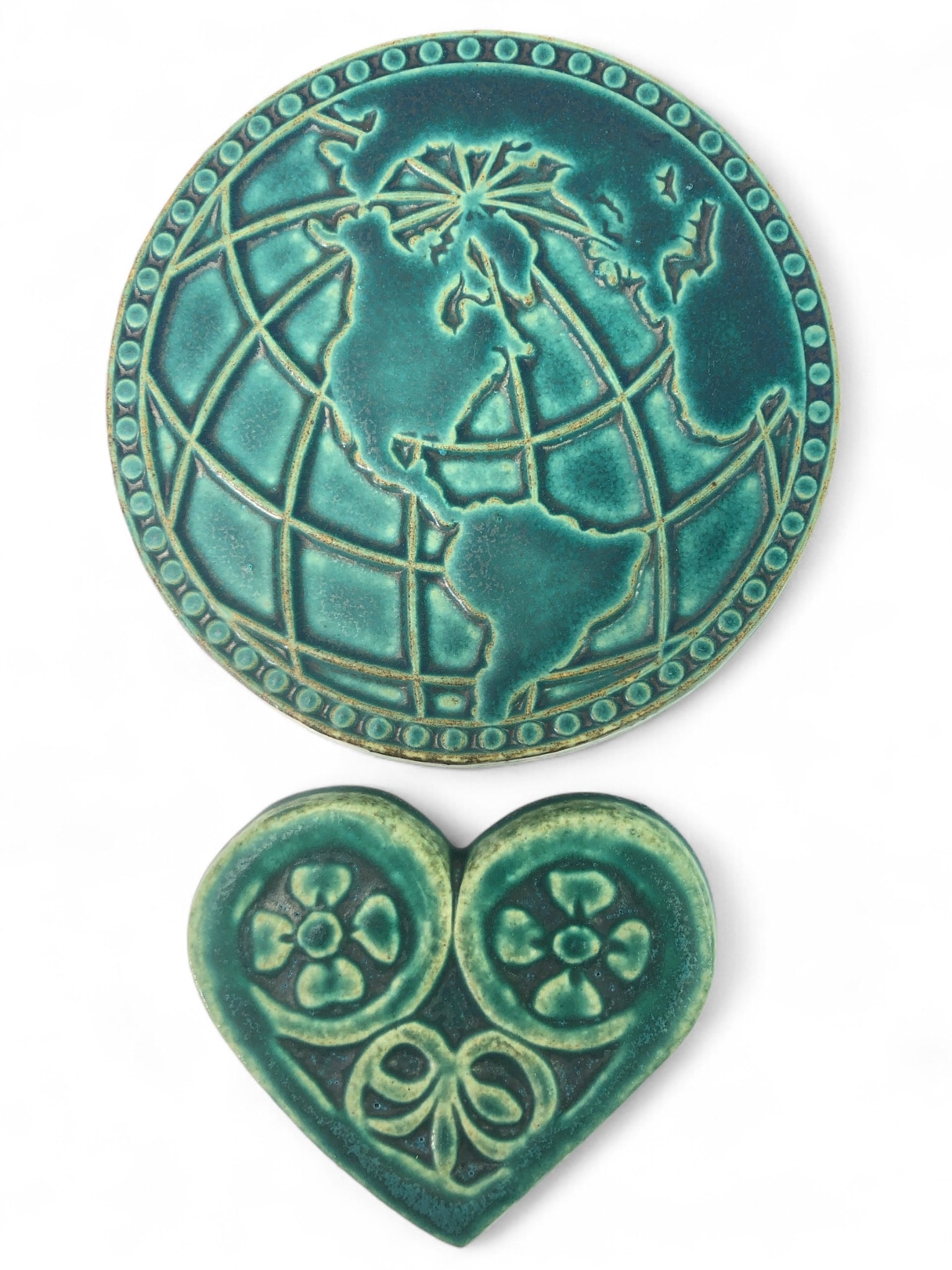 Pewabic Detroit Pottery Globe And Heart: Pewabic Detroit pottery items including a 6 3/4" diameter globe and 5" x 4 1/4" heart. Both are ceramic with an aqua glaze. The globe shows a chip and wear on the edge, no damage noted on the heart.