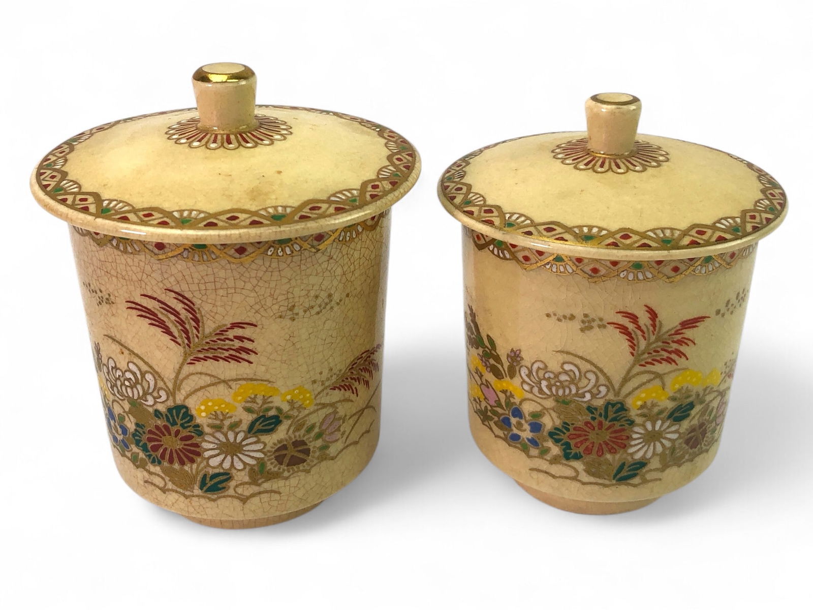 Vtg Satsuma Style Ceramic Tea Cups With Lids: Vintage Satsuma-style ceramic tea cups with lids, featuring crackle glaze and hand-painted floral motifs. Heights of 3 in. and 3 3/8 in. without lids. Includes detailed painted patterns on lids and cu