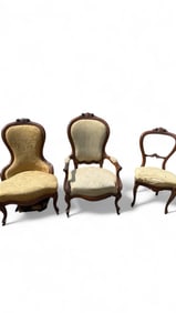 A Group of Three Victorian Rococo Revival Carved Hardwood Chairs