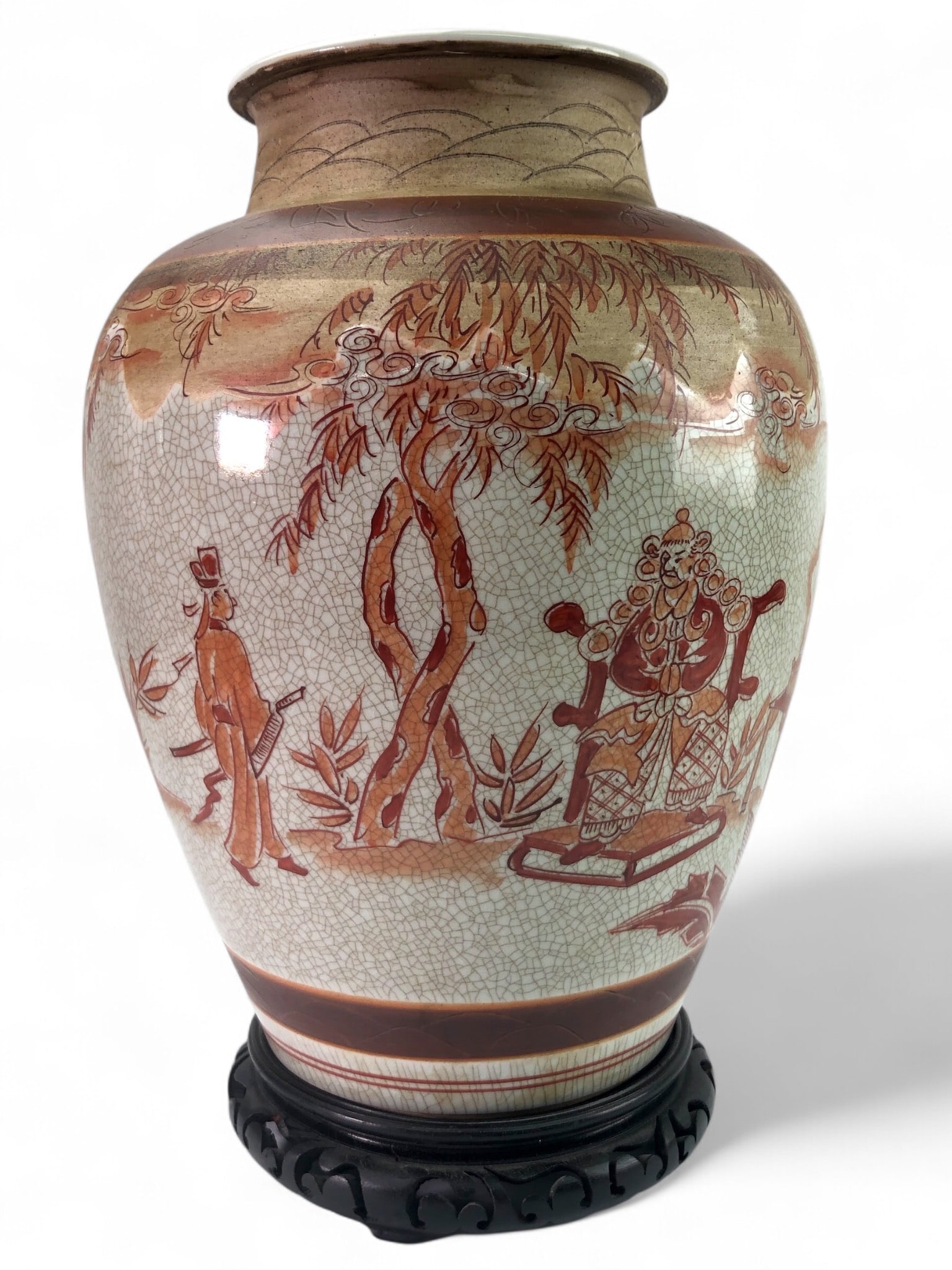 A Japanese Satsuma Hand-Painted Ceramic Vase: A Japanese Satsuma hand-painted ceramic vase of ovoid-form, displayed on a separate carved dark-stained wooden stand.. Measures 14.5 inches tall including the stand. Visible wear and edge chip present