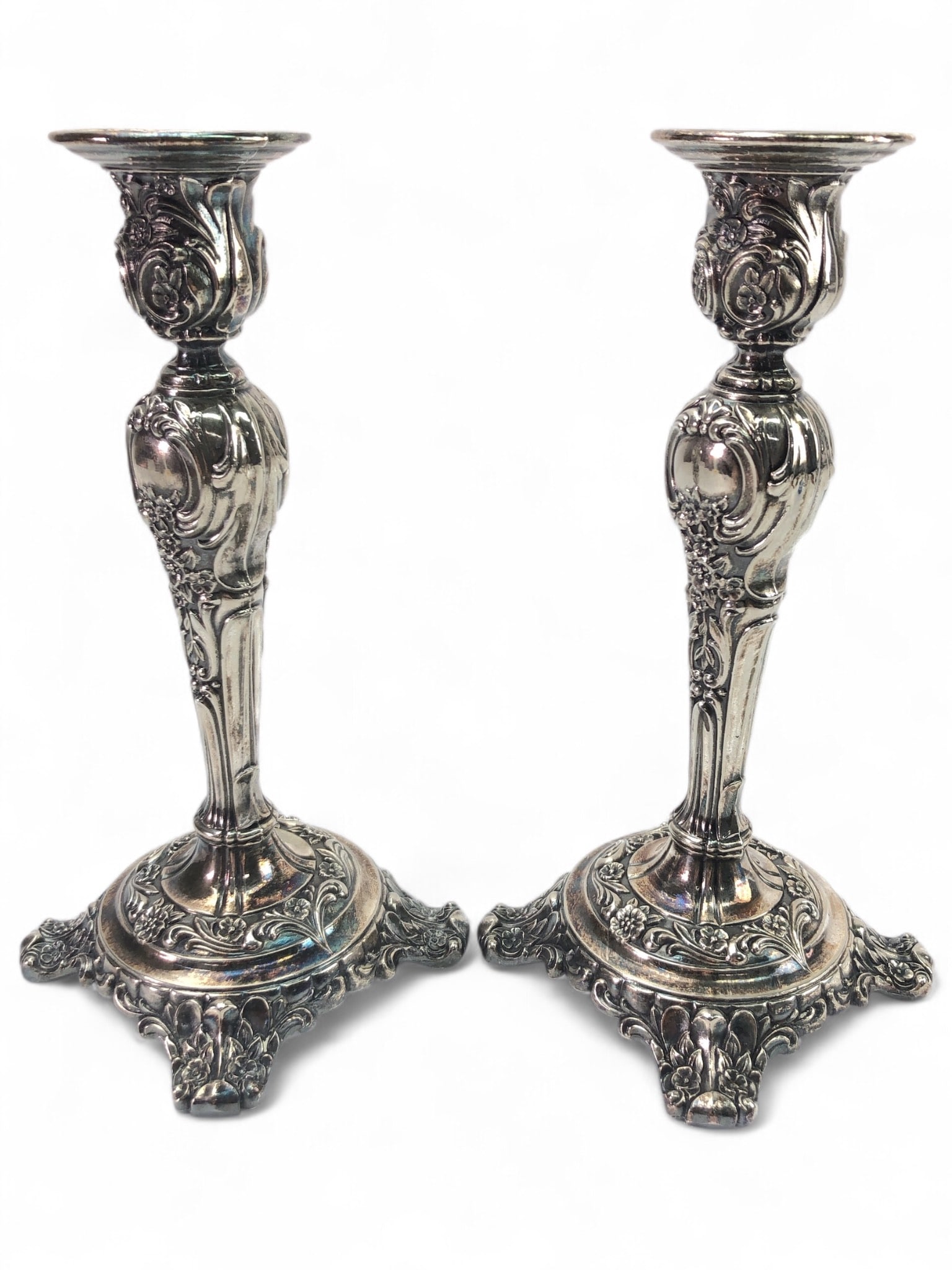 Wm Rogers & Son Silver Candlesticks: Silver-plated candlesticks by Wm Rogers & Son. Each features ornate detailing and measures 8.75 inches tall. Marked "Wm Rogers & Son" on the base. Some tarnish and wear visible, consistent with age an