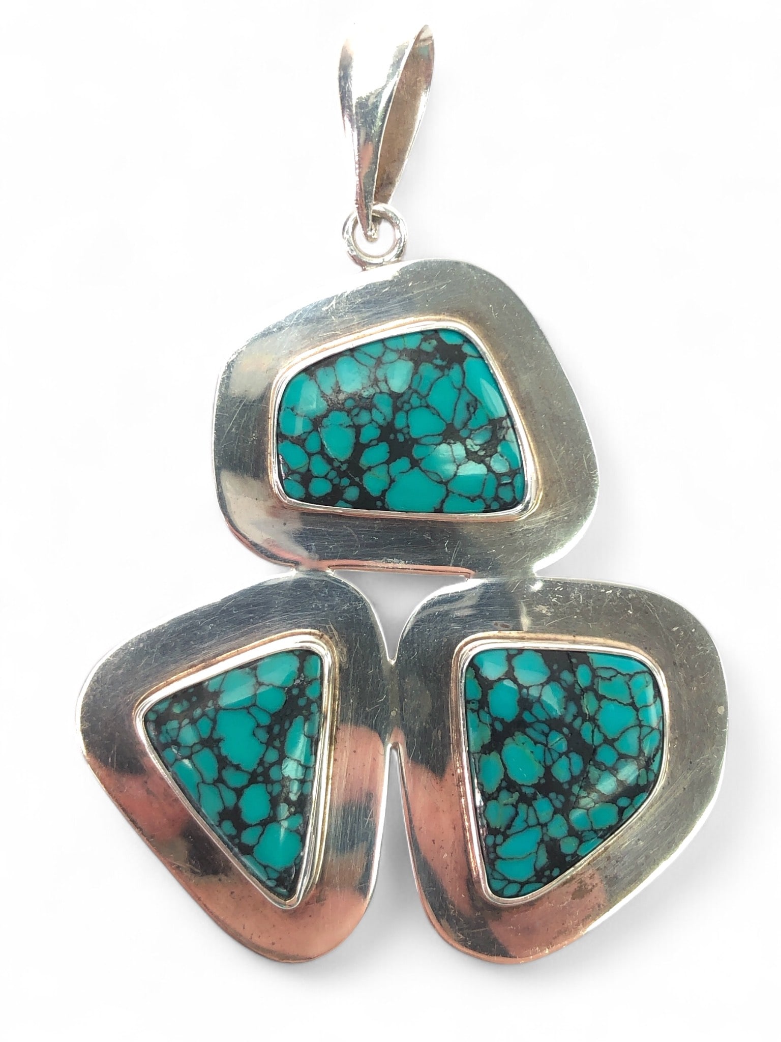 Charles Albert Sterling & Turquoise Pendant: Charles Albert fine sterling silver & turquoise pendant featuring three asymmetrical turquoise stones inlaid in sterling silver. The pendant measures approximately 3 3/8? in height, including the bail
