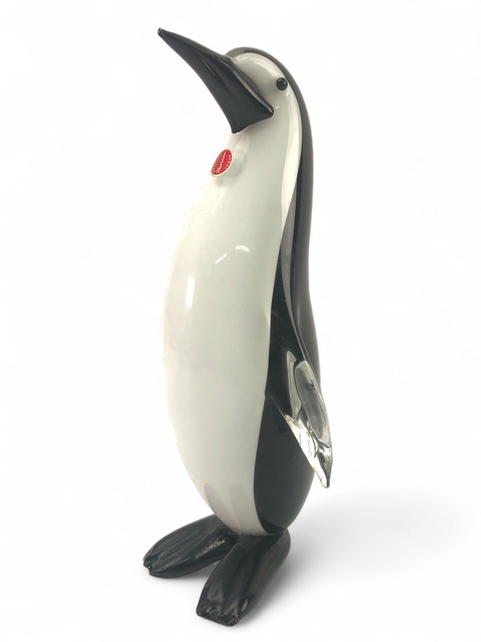 Murano Made In Italy Art Glass Penguin: Murano-made art glass penguin, featuring black, white & clear glass. Red 'Made In Murano Italy' sticker present. Chipped beak & toe, with surface scratches to base. Measures 11 1/8 inches tall.