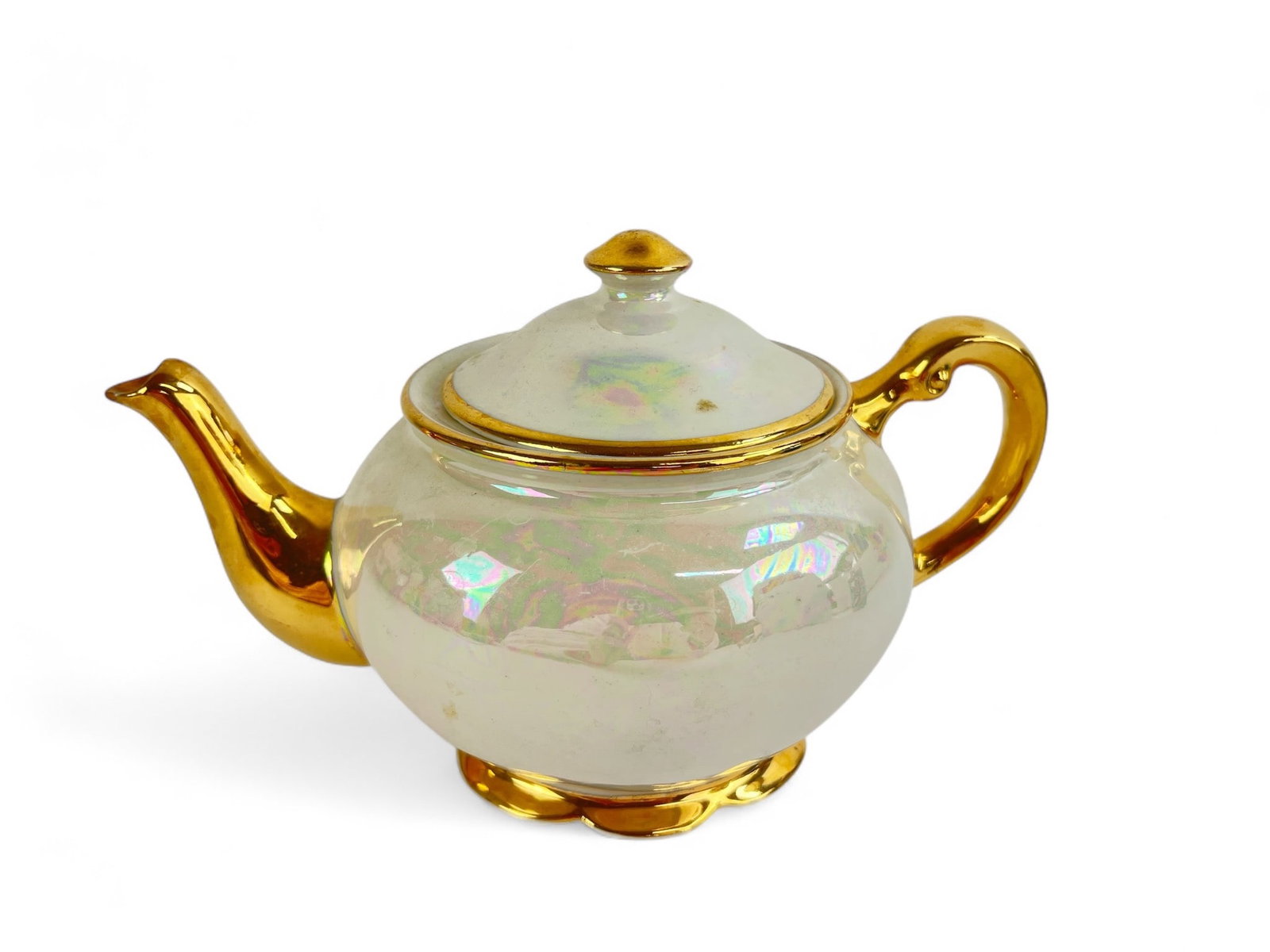 Kingwood China Co. Gold & Pearl Teapot: Kingwood China Co. teapot featuring pearlescent finish & gold accents on the spout, handle, lid, & base. Marked on the bottom. Dimensions are 5.5 inches (top of lid) x 9.5 inches (spout to handle) x 4
