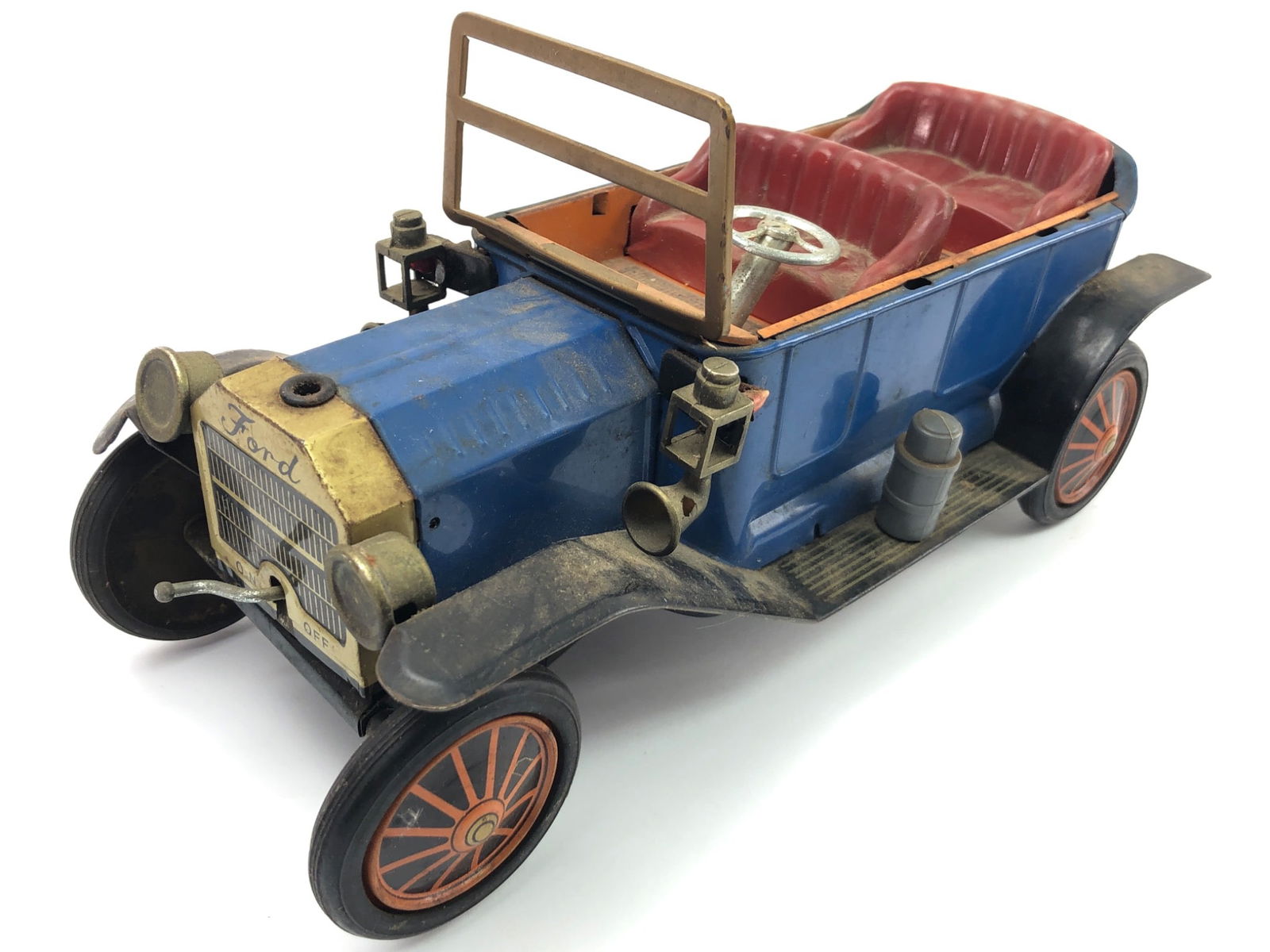 Sunrise Toys Tin Lithographed Ford Model T: Sunrise Toys tin lithographed Ford Model T battery-operated toy car, made in Japan in the 1950s. Measures 10.25 inches long. Features detailed lithograph design with battery compartment, marked Ford o