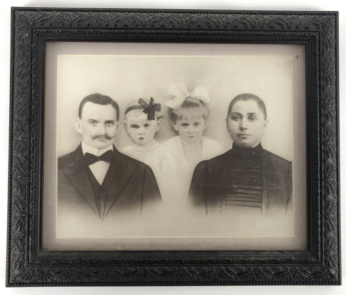 Antique Framed Portrait Of Family: Antique framed portrait of a family with a black decorative frame. The frame measures approximately 12 x 10 inches. The back features a Frames Unlimited sticker, indicating professional framing.