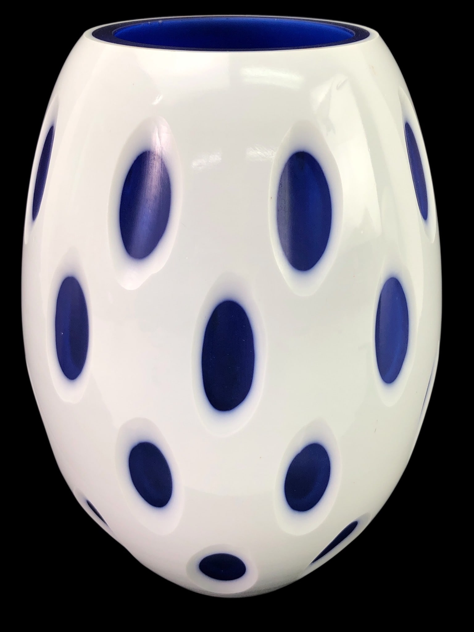 Rare Murano White Cut To Cobalt Blue Glass Vase: Rare mid-century modern Murano oblong white cut-to-cobalt blue glass vase measuring 8.25 inches tall. Features oval cut-outs revealing cobalt blue inner glass. Retains original Lavorazione Arte Murano