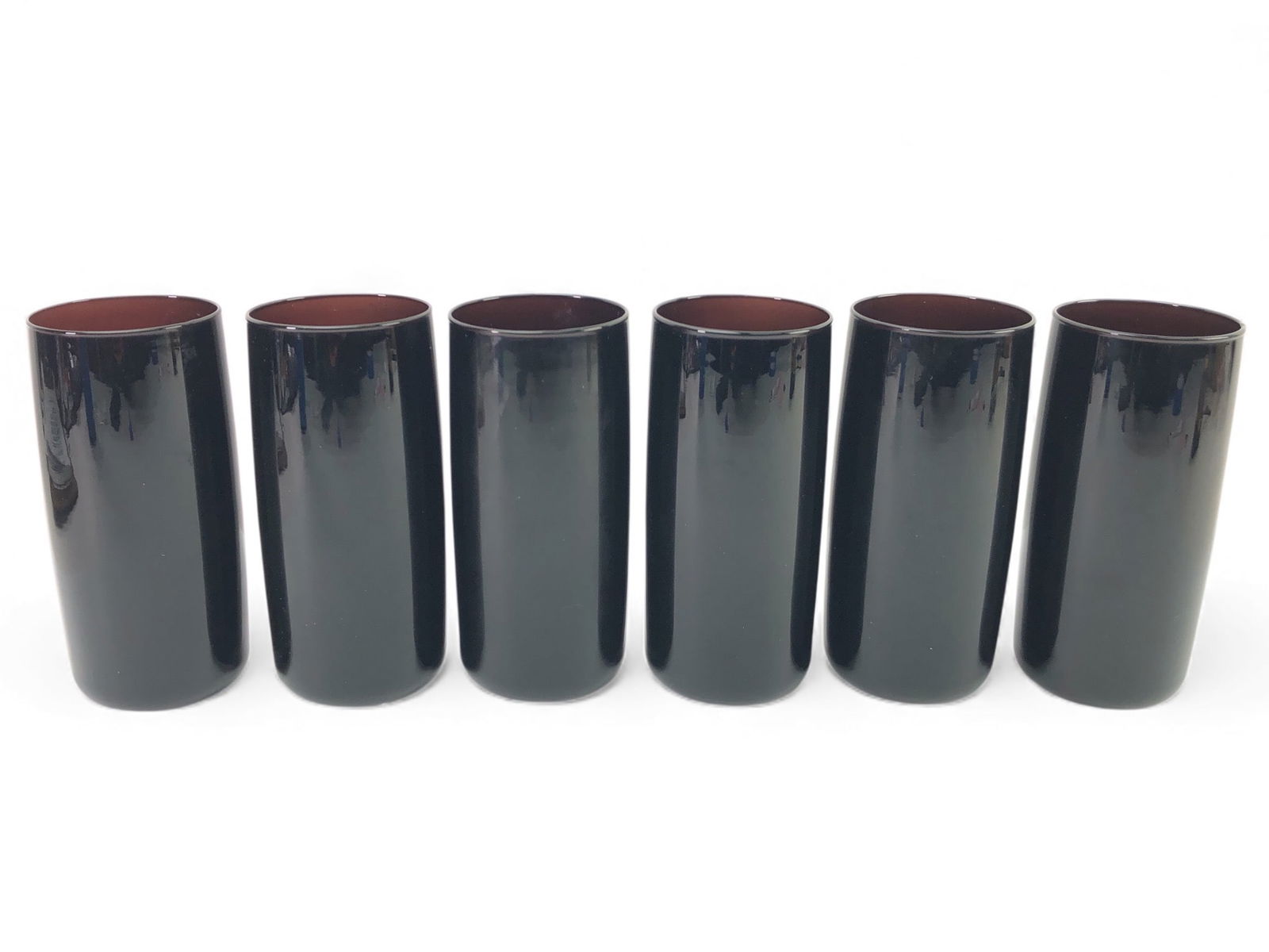 (6) Vtg Libbey Black Amethyst Highball: Six vintage Libbey black amethyst highball glasses, each approximately 6 inches tall. Made of black amethyst glass, featuring a sleek and reflective finish. Marked with the Libbey anchor logo on the b