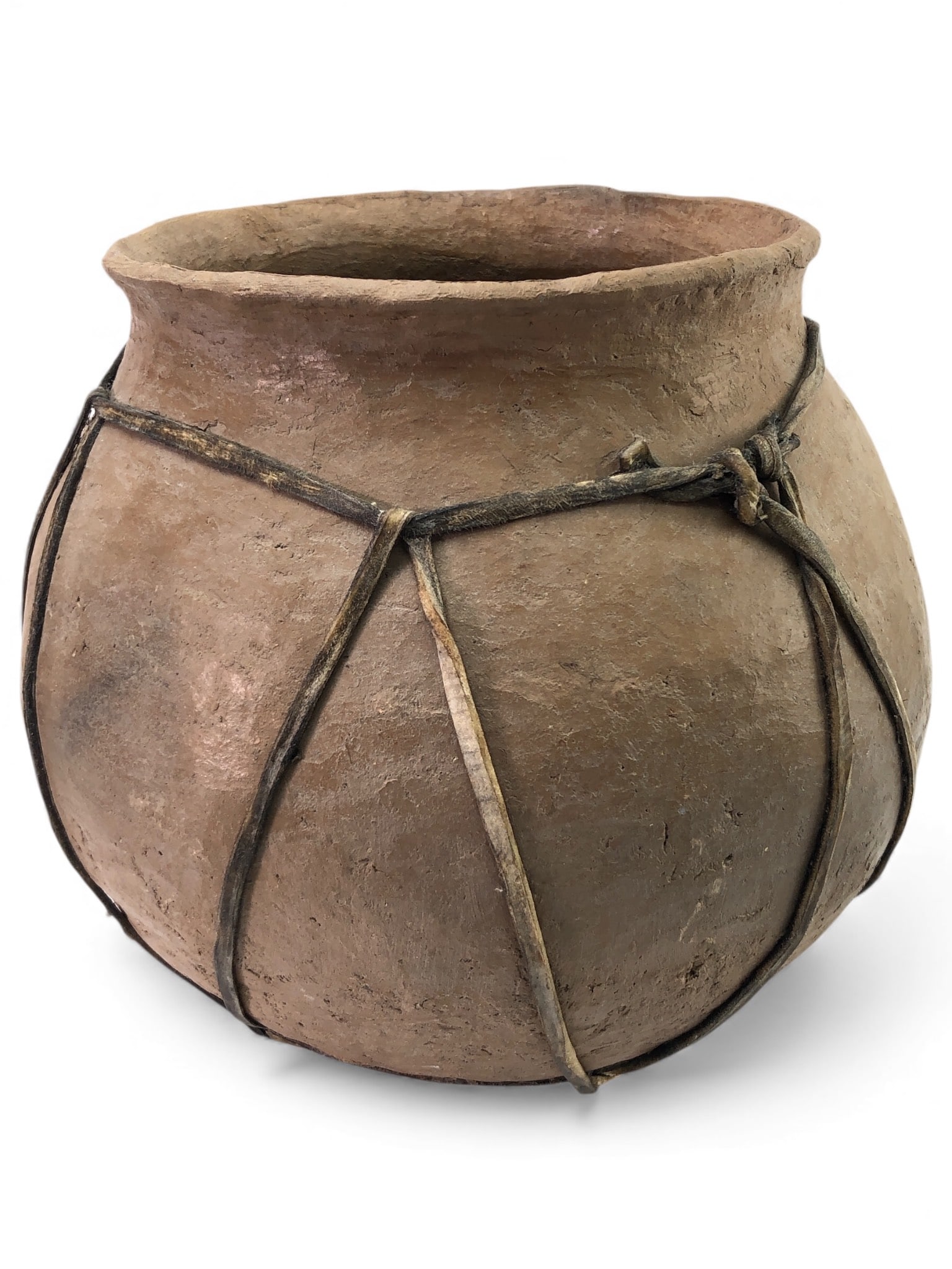 Rare Tarahumara Pottery Olla With Rawhide Wrap: Rare Tarahumara pottery olla, hand-crafted by the Tarahumara indigenous tribe of Mexico. Features a rustic, utilitarian design with rawhide wrap. Made of earthen clay, measures 9.5 inches tall. Known