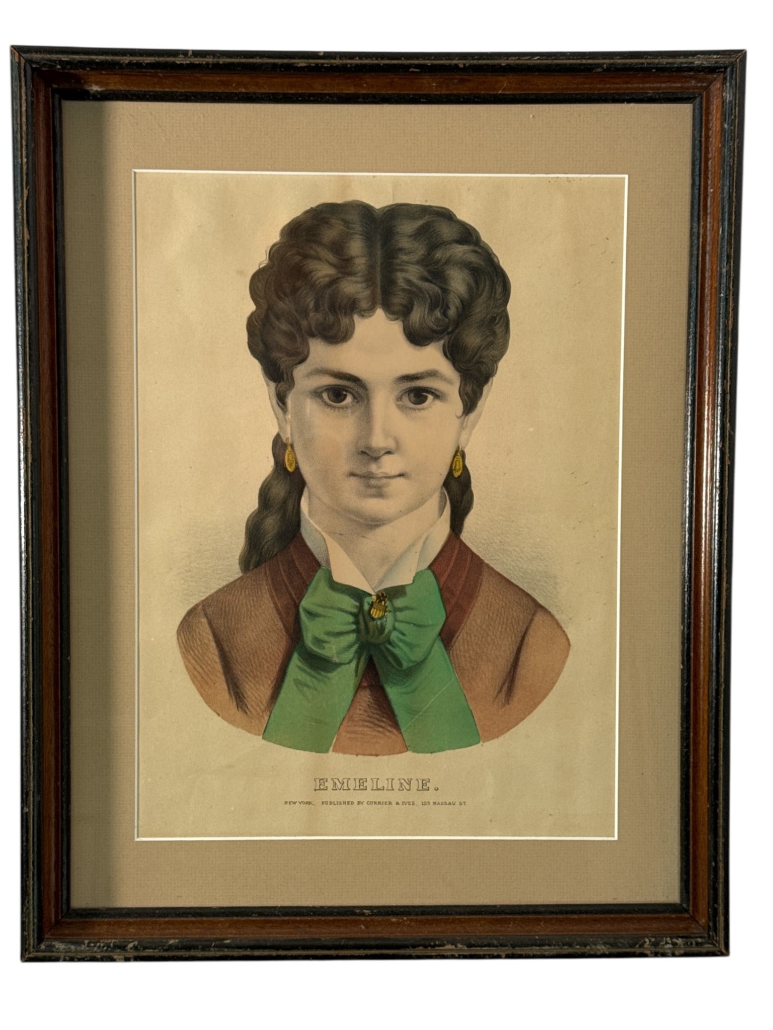 Currier & Ives Hand-Colored Lithograph Emeline: 15x19 inch Currier & Ives hand-colored lithograph titled 'Emeline.' Published by Currier & Ives, 125 Nassau St, New York. Framed under glass in a wooden frame with visible wear. Backing intact with ha