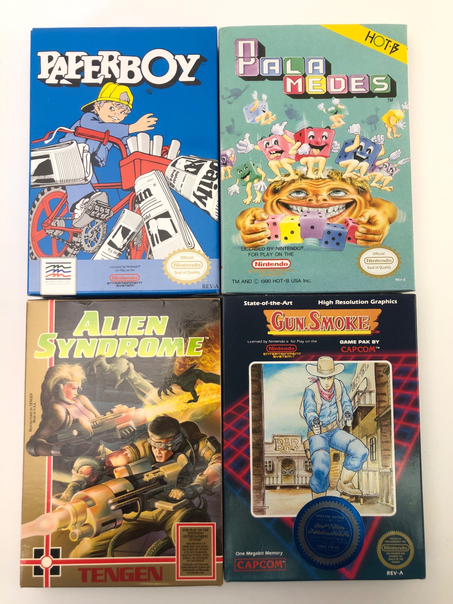 4 NES Games: Paperboy, Palamedes & More: 4 NES games including Paperboy by Mindscape, Palamedes by HOT-B, Gun.Smoke by Capcom & Alien Syndrome by Tengen. Each game includes cartridge, original box & manual. Boxes show light wear. Cartridges 