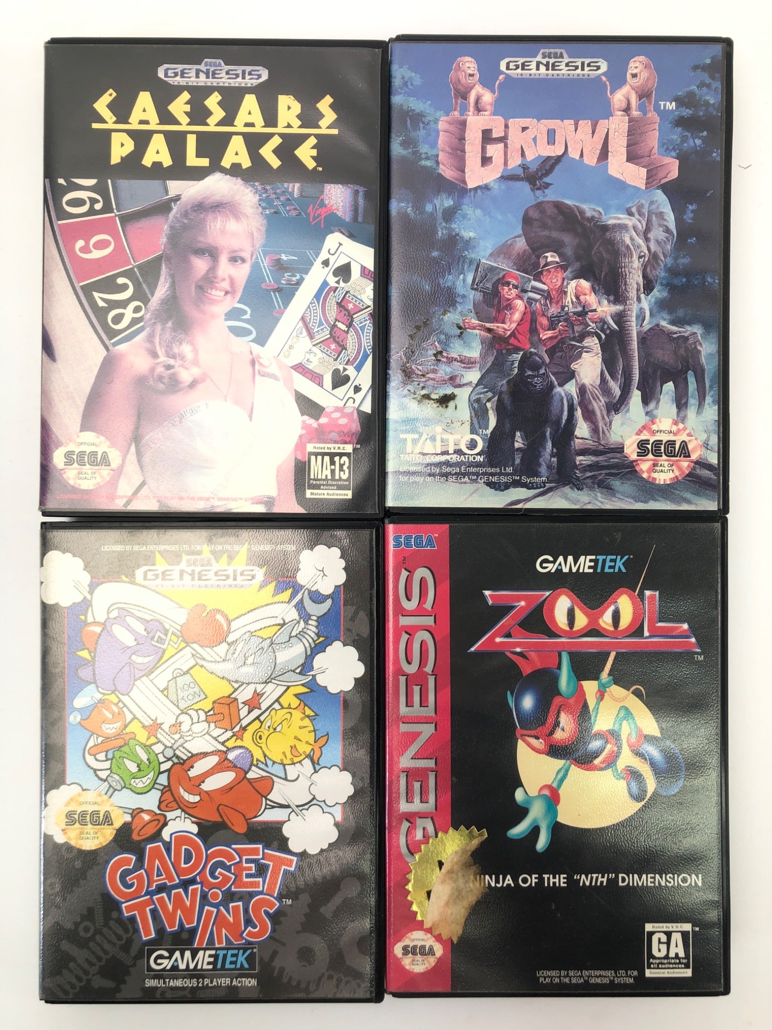Sega Genesis Caesars Palace, Growl, Gadget Twins & Zool: 4 Sega Genesis games, including Caesars Palace, Growl, Gadget Twins & Zool. Includes cartridges & cases; manuals included for Caesars Palace & Growl. Shows wear, stickers, & markings on cartridges. Id