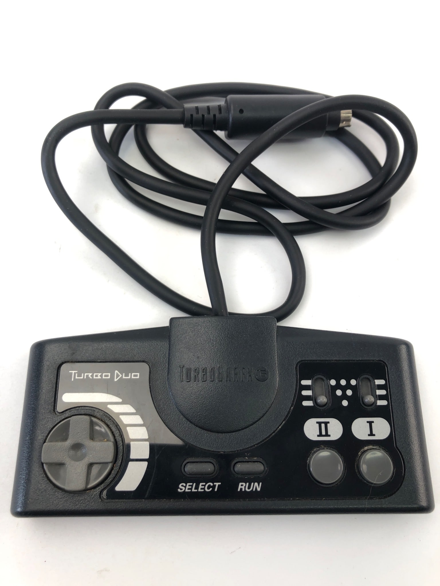 Turbo Duo Controller By NEC: Turbo Duo controller by NEC featuring directional pad, Select & Run buttons, dual action buttons, and six-pin connector. Designed for use with the Turbo Duo console. Moderate wear on the housing. Cord