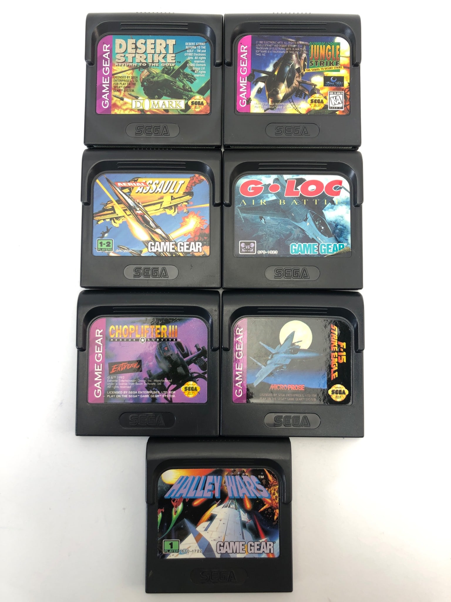 Sega Game Gear Jet & Rocket Game Lot: 7 Sega Game Gear cartridges including Desert Strike, Jungle Strike, G-LOC Air Battle, Choplifter III, P-51 Mustang Fighter, Battle Wings, & Super Battle Tank. Games are untested with typical wear for