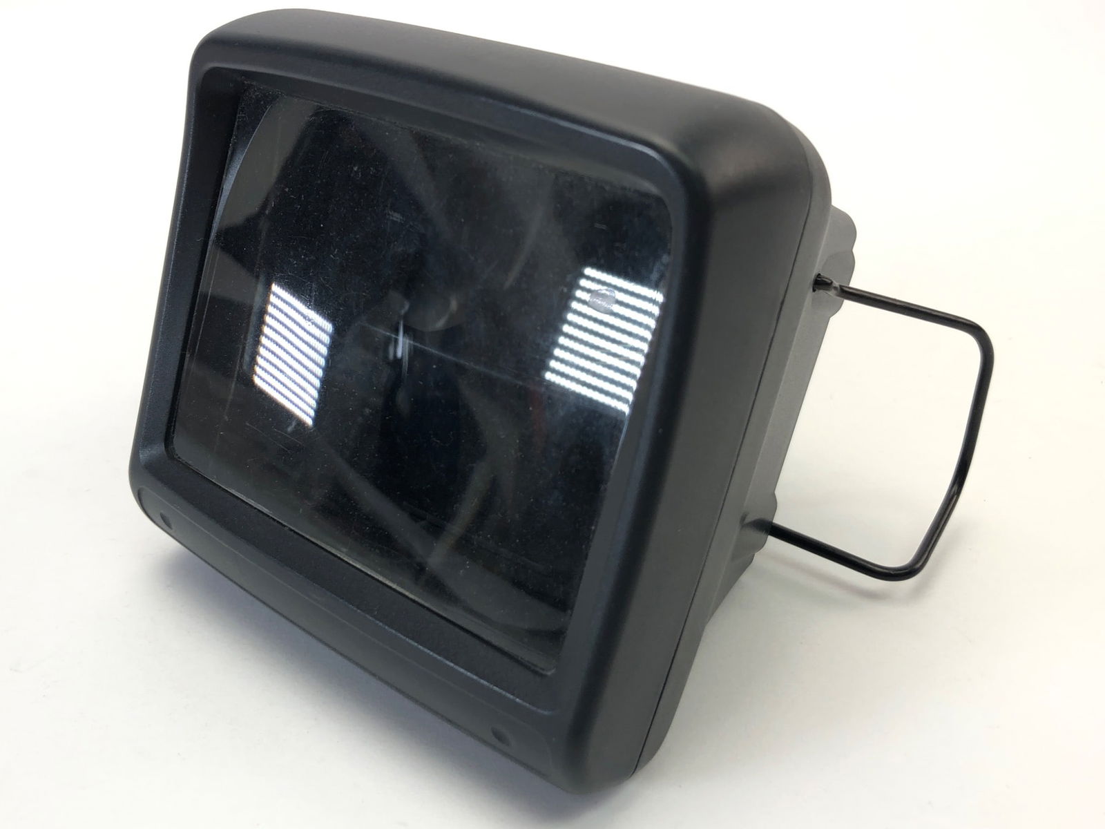 Sega Super Wide Gear Attachment: Sega Super Wide Gear attachment for the Game Gear console. Features a magnifying lens to enhance the handheld gaming experience. Black plastic housing with metal supports. Shows typical wear from use.