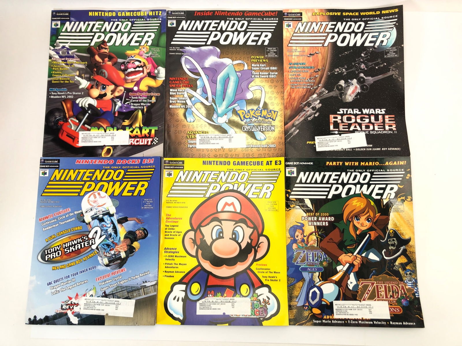 6 Nintendo Power Magazines Featuring Mario & Zelda: 6 Nintendo Power magazines featuring iconic games and characters, including Mario Kart, The Legend of Zelda, Tony Hawk's Pro Skater 2, Star Wars Rogue Leader, Pokemon Crystal Version, and more. Covers