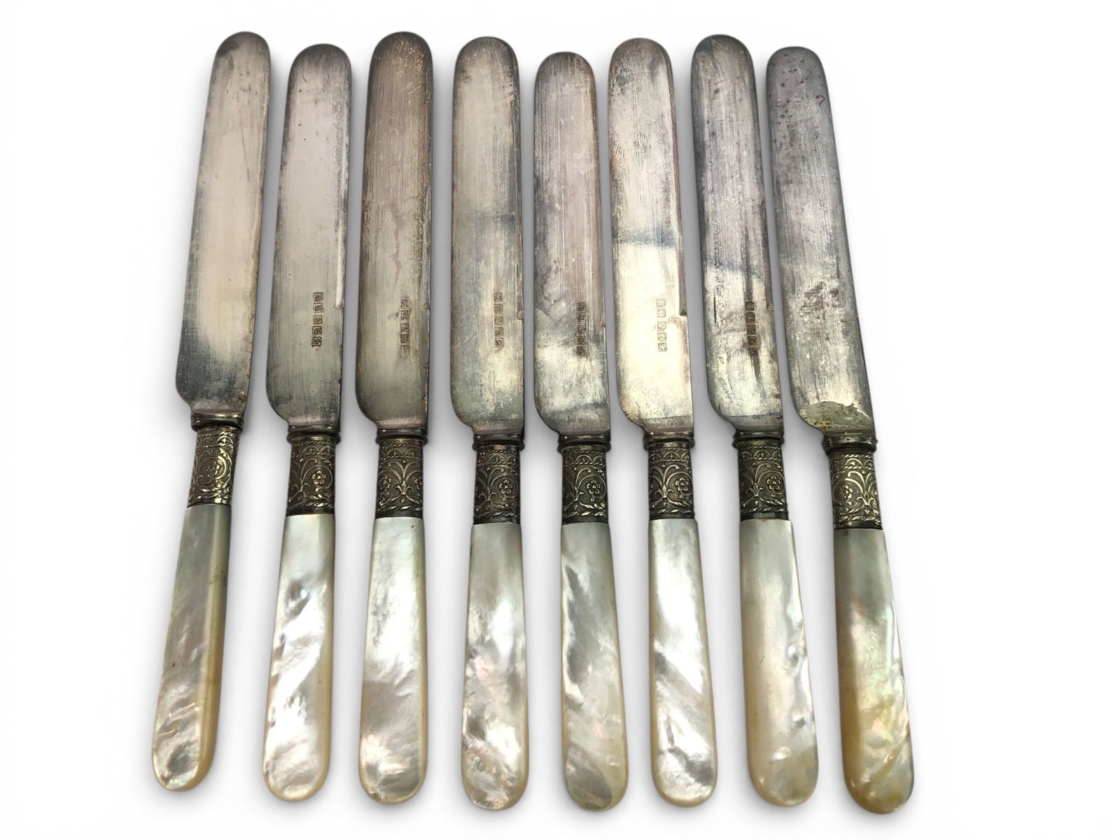 8 Landers Frary & Clark Knives: 8 sterling silver & mother of pearl knives by Landers, Frary & Clark. Each knife features a sterling blade with decorative detail, mother of pearl handles, & measures approximately 7 3/4 inches in len