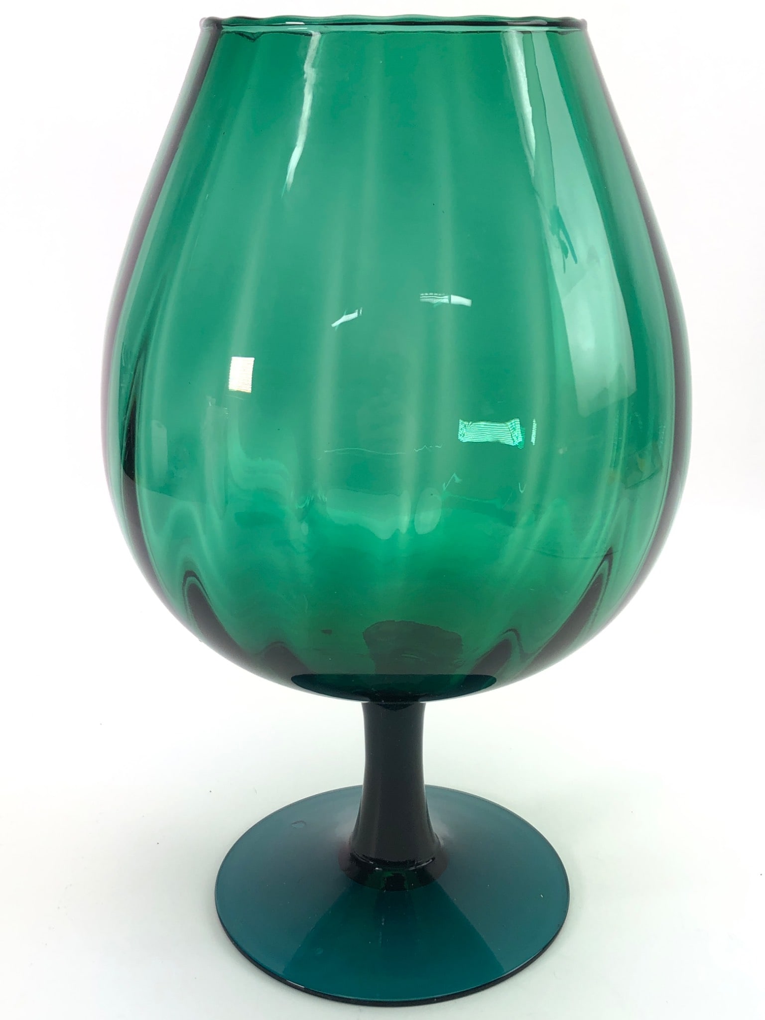 MCM Empoli Italian Art Glass Teal Snifter: Mid-century modern Empoli Italian art glass teal snifter. Stands 12 inches tall. Features a ribbed teal design with a flared pedestal base. Shows a chip along the edge of the rim and wear to the base.