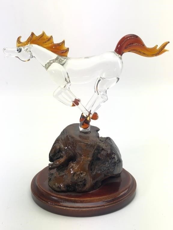 Glass Gallery Horse On Wood Base: Glass horse figurine featuring orange mane & tail with glitter details, mounted on a wooden base. Measures 6 inches tall. Hand-made in China by Glass Gallery as indicated by the label on the underside