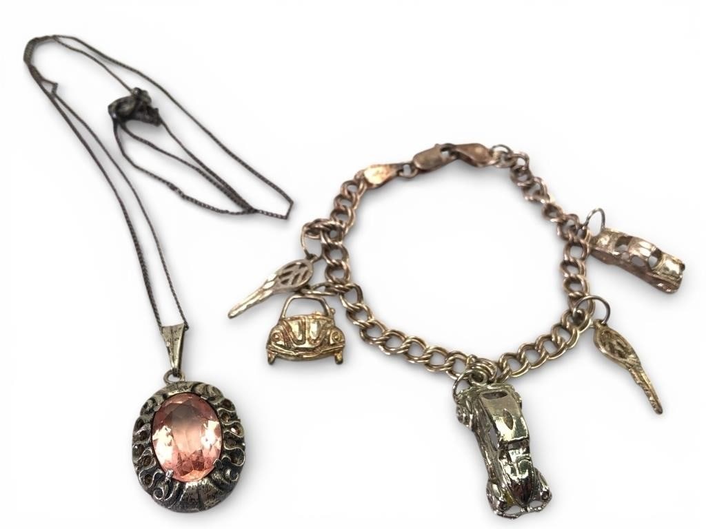 Sterling Charm Bracelet & Pendant Necklace: Sterling silver lot includes a charm bracelet weighing 12.82 grams with various charms and a necklace with a pink gem-like pendant weighing 5.12 grams. Bracelet marked '925' & 'Made in Italy'. Necklac