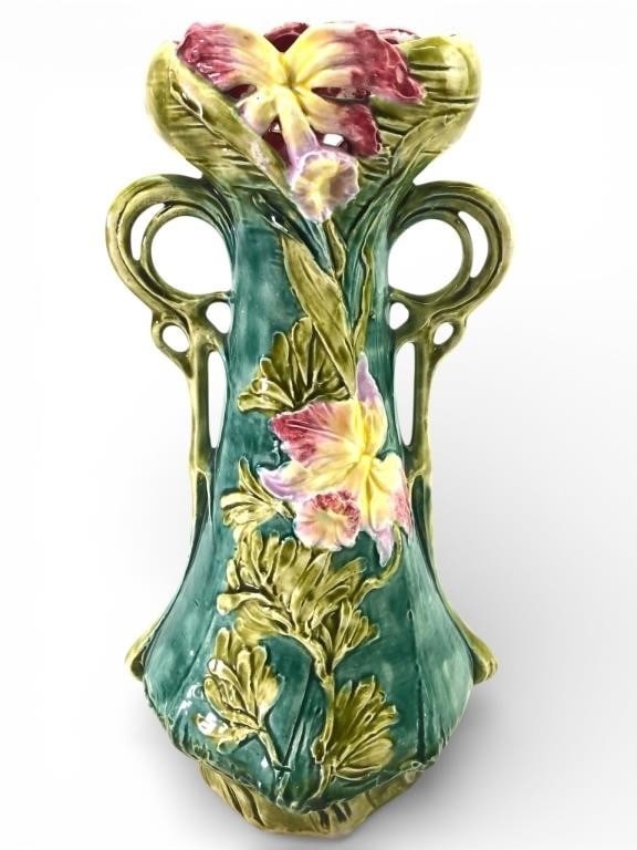 Majolica Vase With Floral Motif 12 Tall: Majolica vase standing 12 inches tall featuring an intricate floral motif with pink, yellow, & green hues. The vase displays a double-handled design with detailed sculptural accents. Marked '2481' on