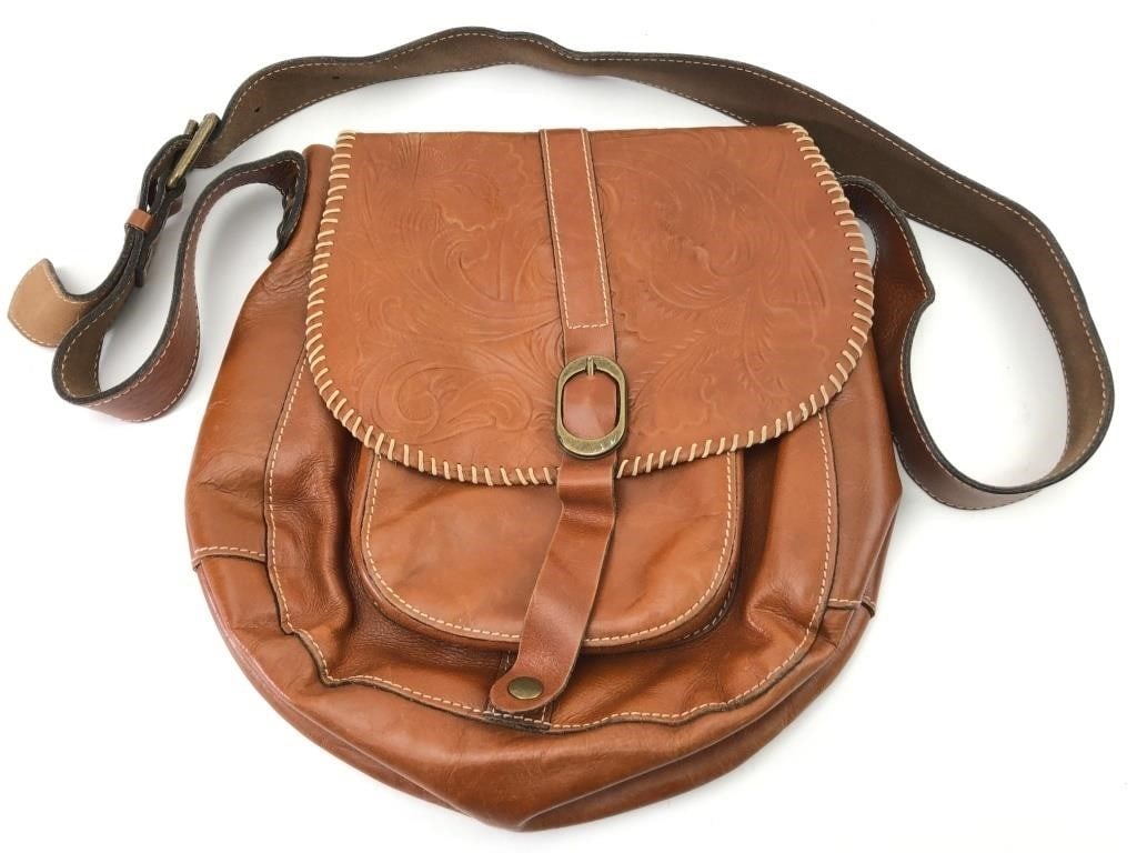 Patricia Nash Tooled Leather Crossbody Bag: A Patricia Nash crossbody bag crafted from cognac-toned leather with floral-tooled detailing on the front flap. The bag features a whipstitched edge, an adjustable shoulder strap with brass-tone hardw