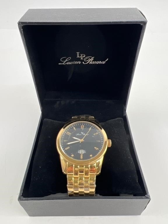 Lucien Piccard Gold-Tone Watch With Box: Lucien Piccard gold-tone wristwatch featuring a black dial with date display at 6 o"clock and gold-tone hour markers. Includes matching gold-tone bracelet and original box. Comes with tag. The watch