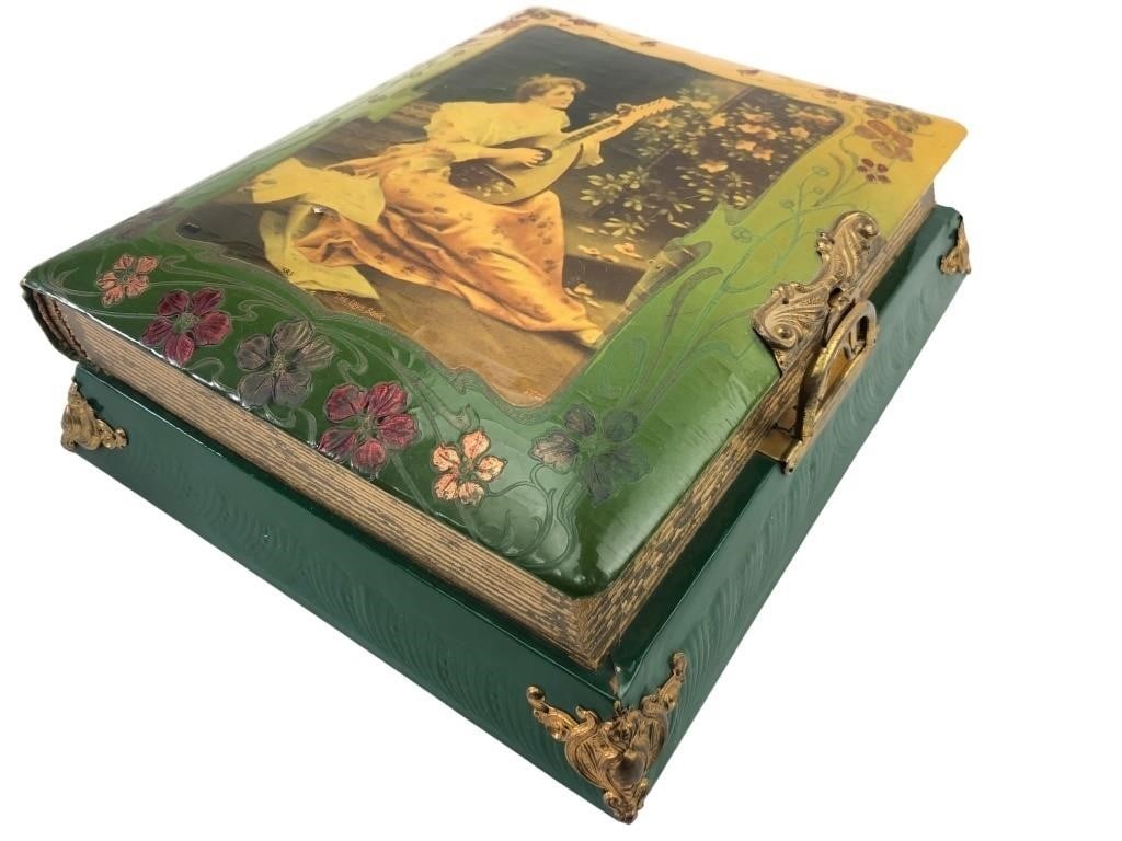 Swiss Musical Photo Album with Art Nouveau Cover: Art Nouveau musical photo album featuring a celluloid cover with a lithograph titled "The Love Song" depicting a woman playing a lute. The green embossed base contains a Swiss-made music box playing "