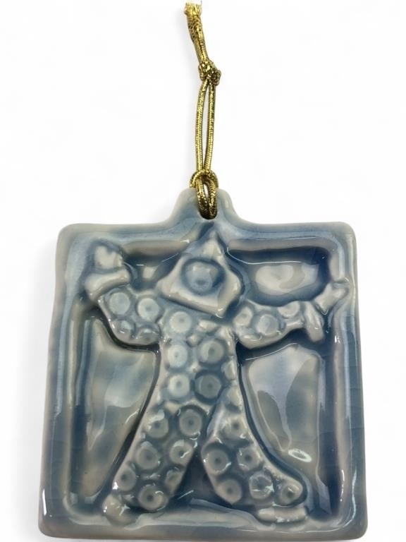 Pewabic Pottery Clown Ornament: A ceramic clown ornament by Pewabic Pottery, Detroit. This square-shaped piece features a raised relief of a polka-dot clown in a light blue and white glaze. The reverse is unglazed and bears the impr