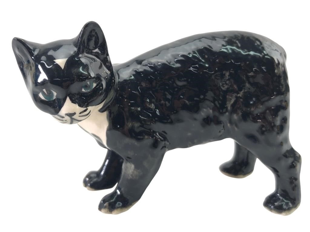 Rare Rushton Pottery IOM Porcelain Tuxedo Cat: Rare porcelain tuxedo cat figurine by Rushton Pottery, Isle of Man (I.O.M.). This hand-painted piece features a black and white glazed finish with green eyes and a textured coat. Marked on the undersi