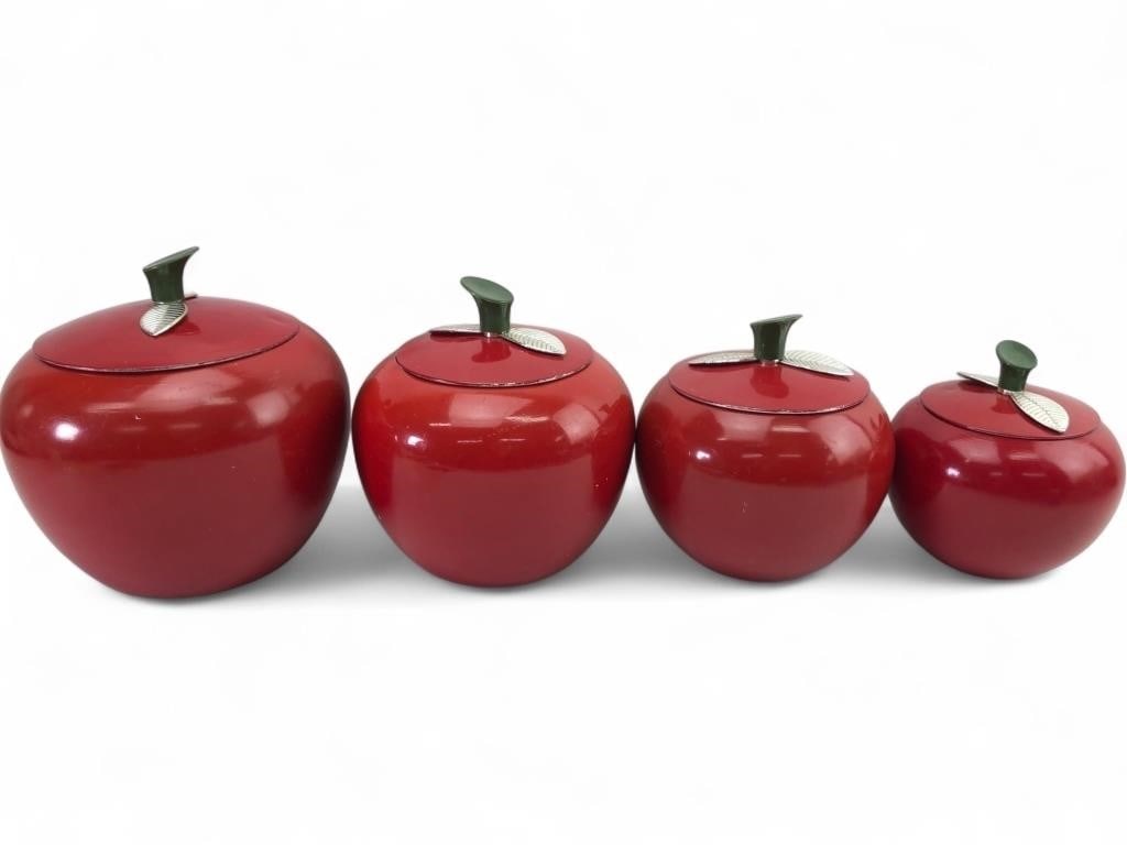 VTG 1950s West Bend Aluminum Apple Canister Set: Set of four vintage 1950s graduated apple-shaped kitchen canisters. Attributed to West Bend, these canisters are constructed from spun aluminum with a vibrant red enameled finish. Each lid features a