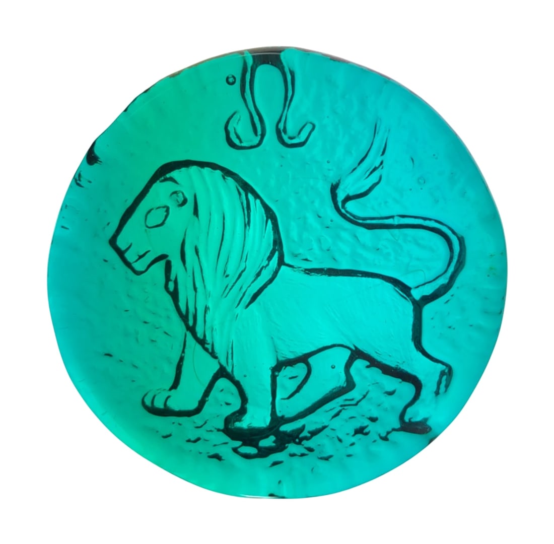 VTG Blenko Azure Blue Glass Leo Zodiac Paperweight: Vintage Blenko art glass paperweight in azure blue, featuring a pressed design of the Leo zodiac sign. Hand-blown construction with a textured, ice-like reverse side. Unmarked. 4" dia.