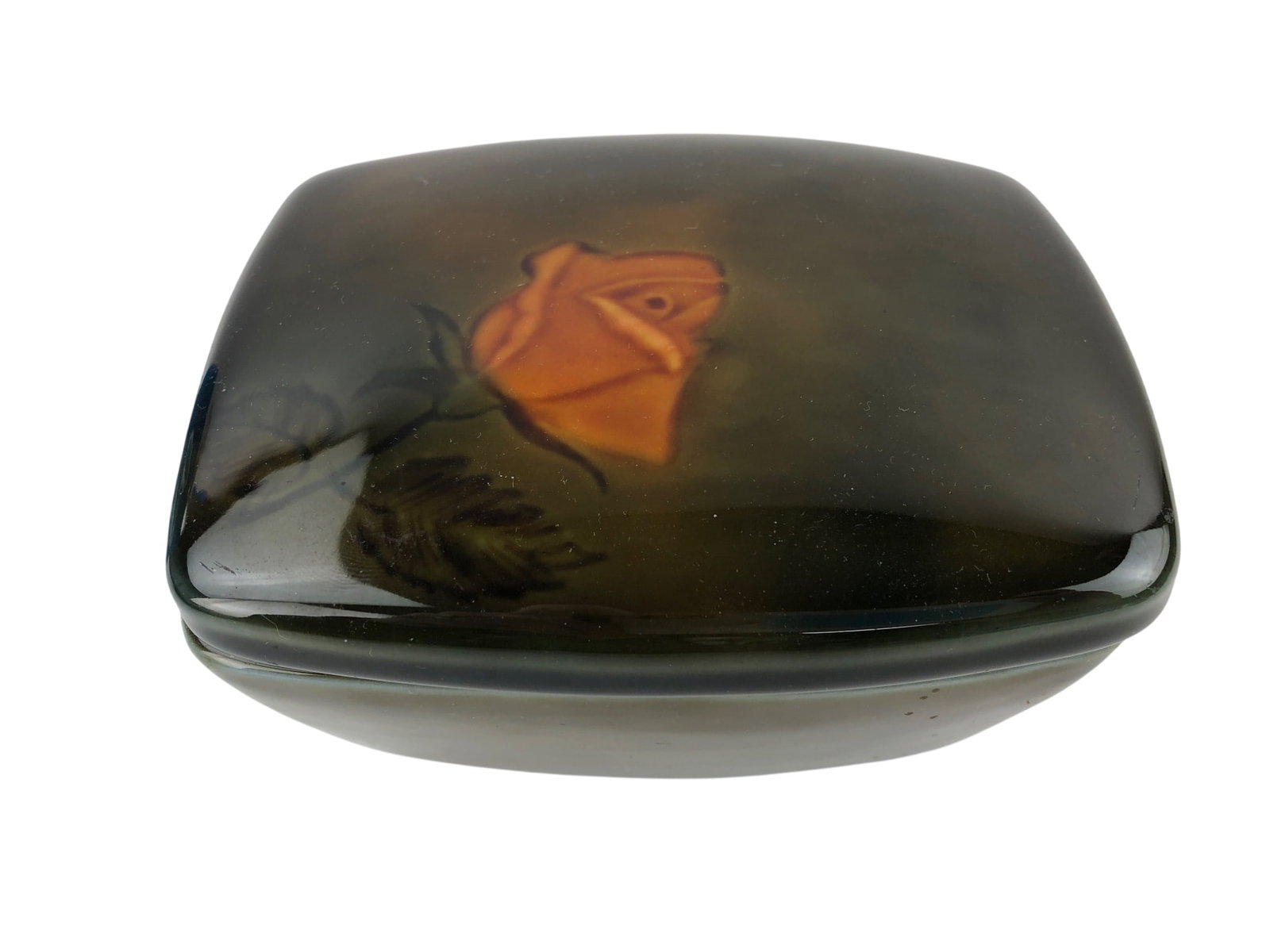Wade Ireland Porcelain Lidded Trinket Box: A rectangular porcelain trinket box with a fitted lid, made by Wade Ireland. The lid features a hand-painted orange rose motif against a dark, shaded green and brown ground. The interior and base are 